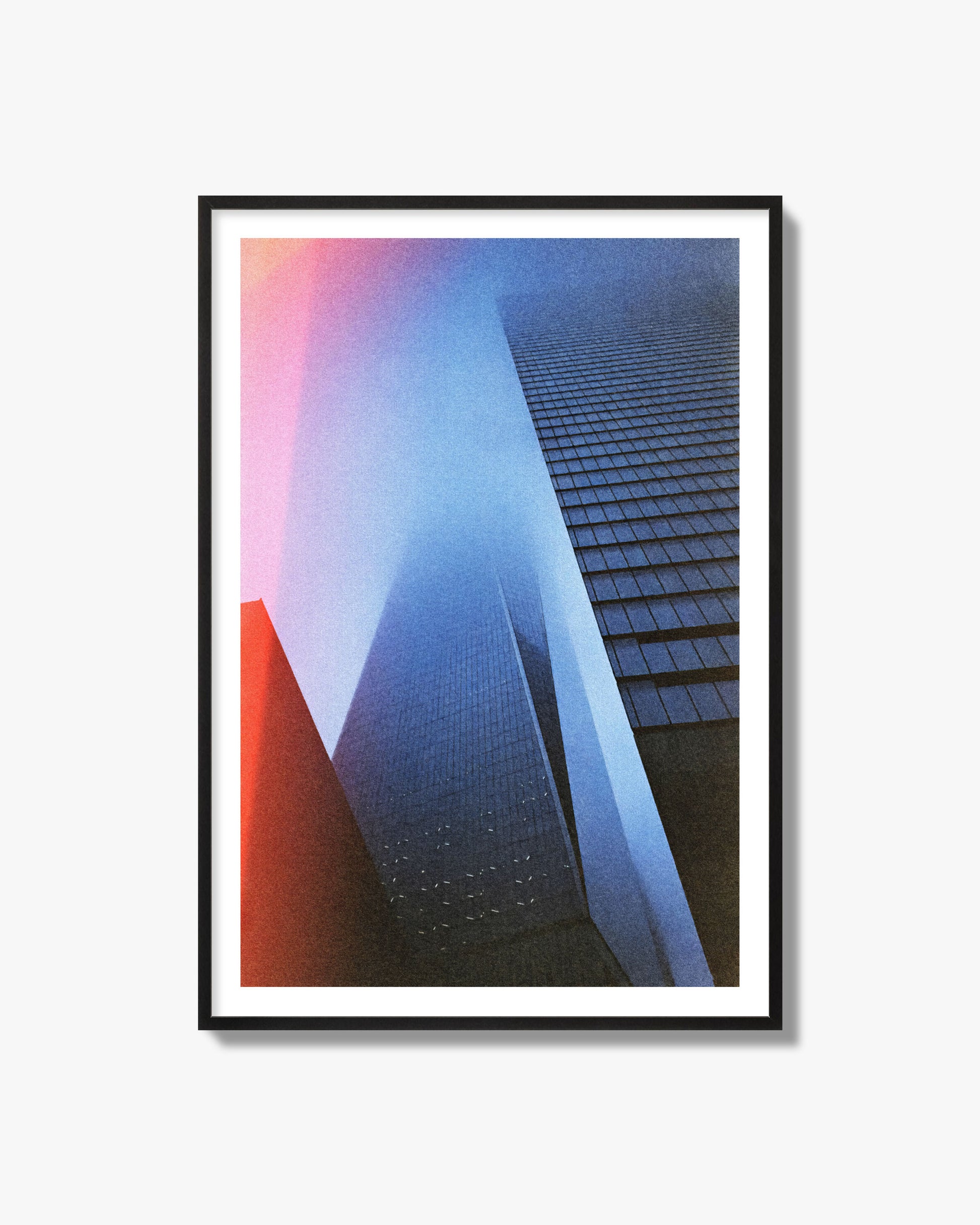 Fine art street photograph of the World Trade Center highlighting geometric shapes, with a dreamlike, cinematic feel in predominantly blue and red hues, archival pigment print in a black frame.