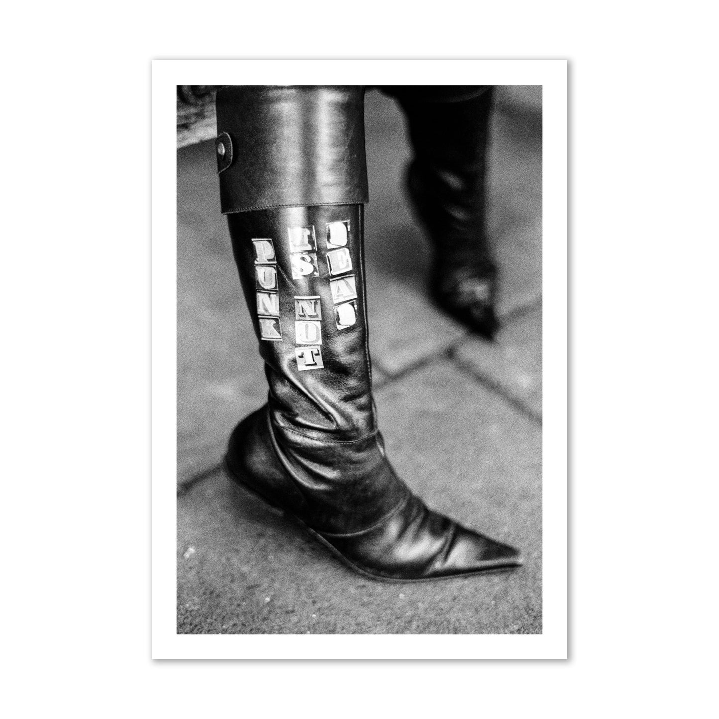 Fine art black and white photo of a woman's black leather boot with the words Punk is Not Dead, archival pigment print, gallery size, unframed.