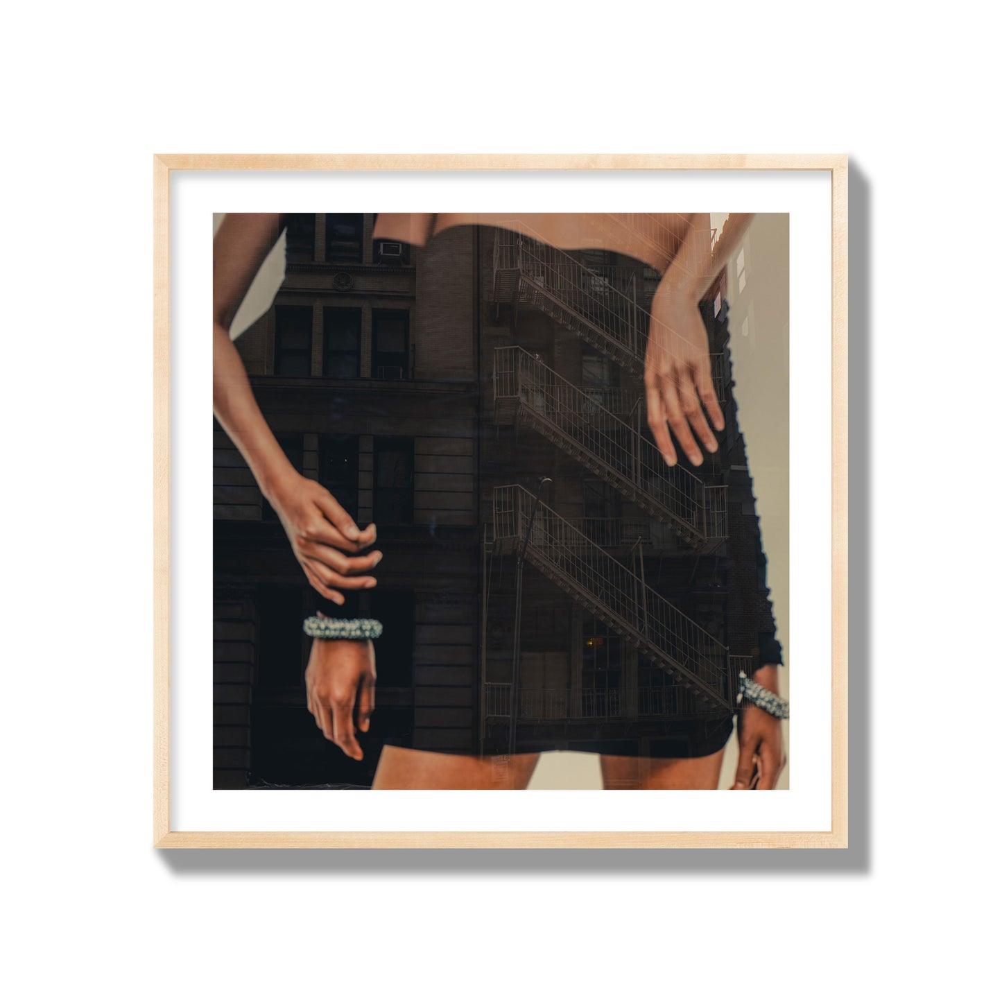 Fine art photograph of two women in black dresses, with the pattern of a fire escape reflected across the fabric, archival pigment print, collector size, natural frame.