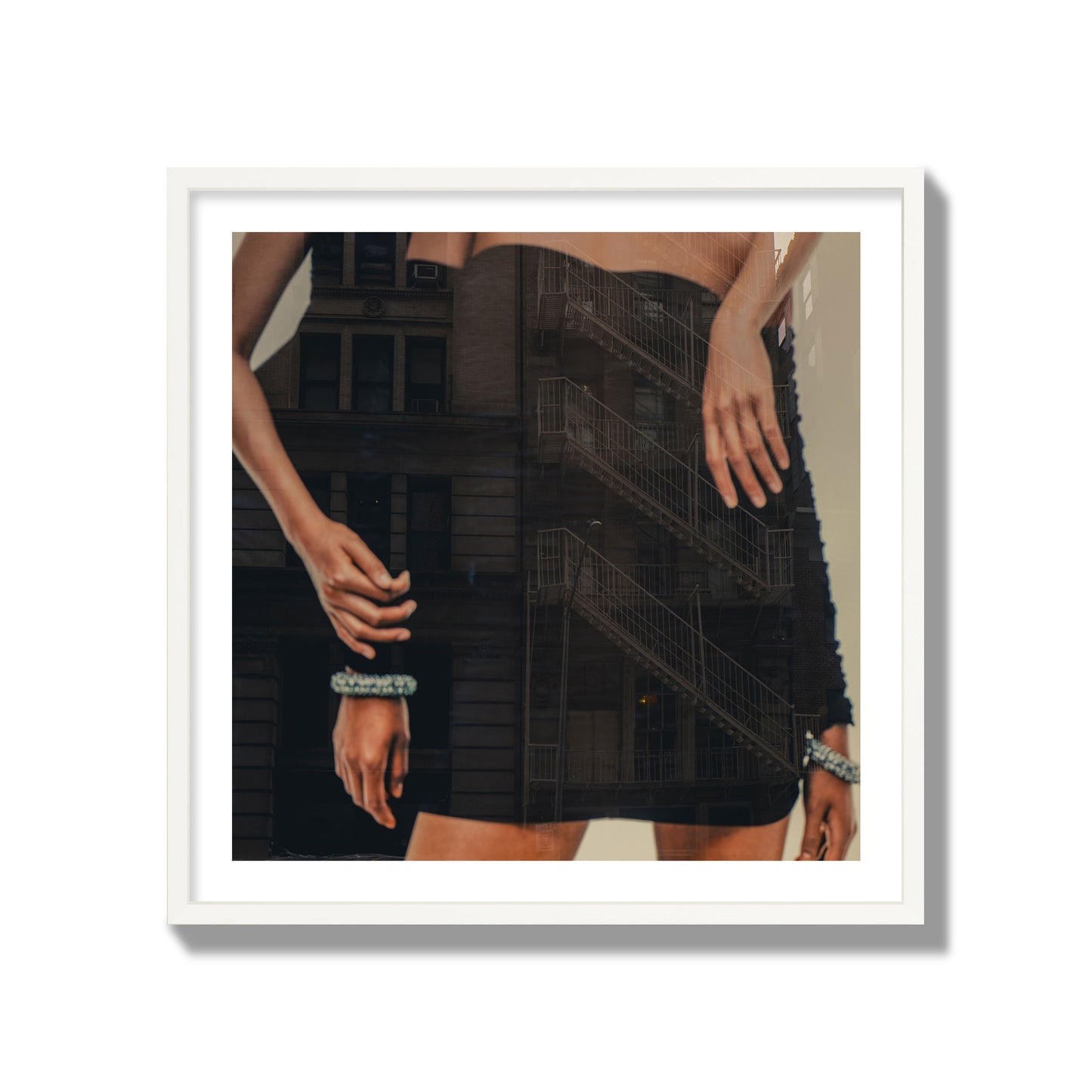 Fine art photograph of two women in black dresses, with the pattern of a fire escape reflected across the fabric, archival pigment print, collector size, white frame.