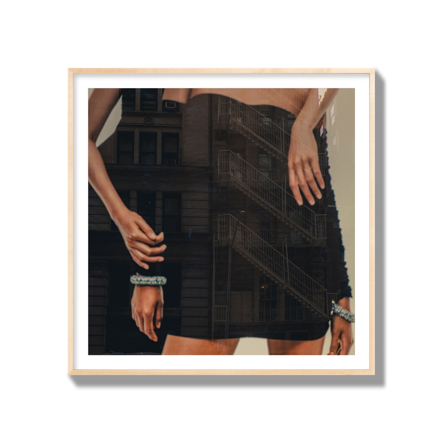 Fine art photograph of two women in black dresses, with the pattern of a fire escape reflected across the fabric, archival pigment print, gallery size, natural frame.