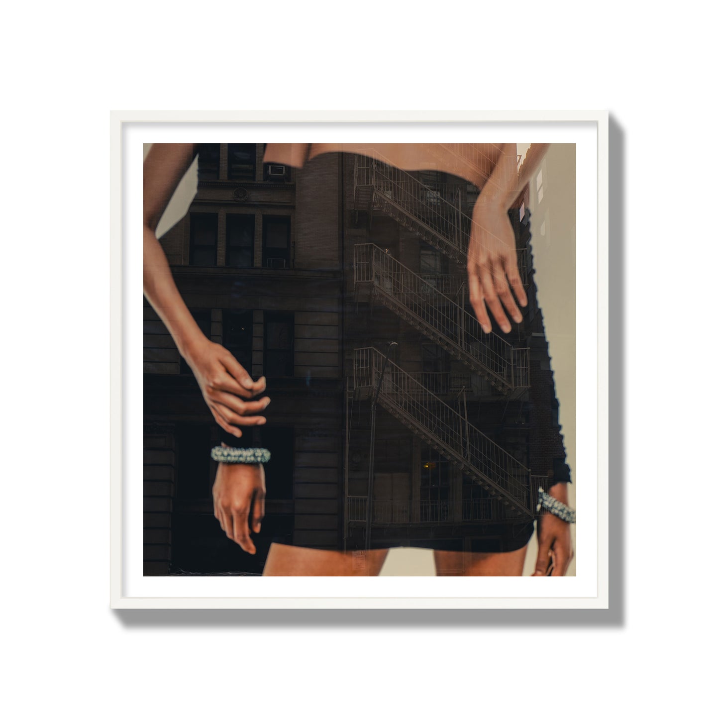Fine art photograph of two women in black dresses, with the pattern of a fire escape reflected across the fabric, archival pigment print, gallery size, white frame.