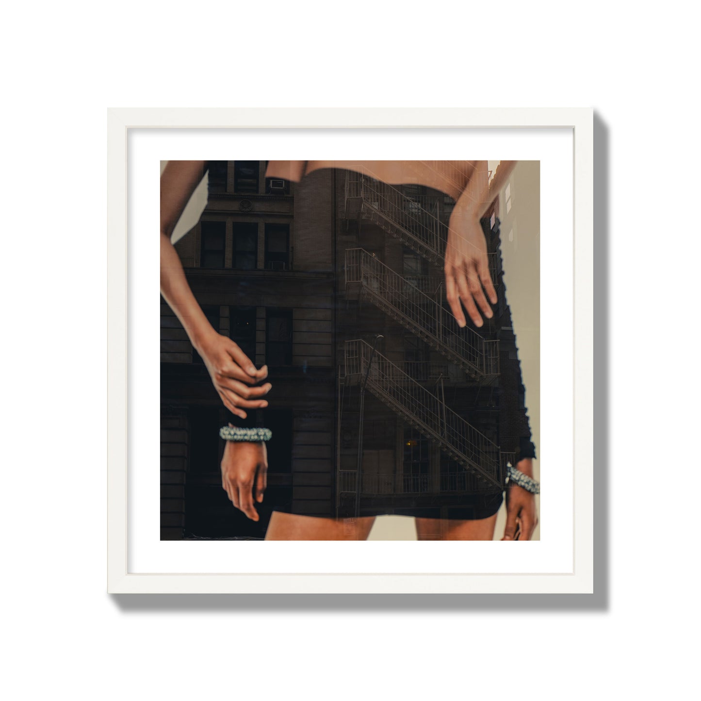 Fine art photograph of two women in black dresses, with the pattern of a fire escape reflected across the fabric, archival pigment print, giant size, white frame.