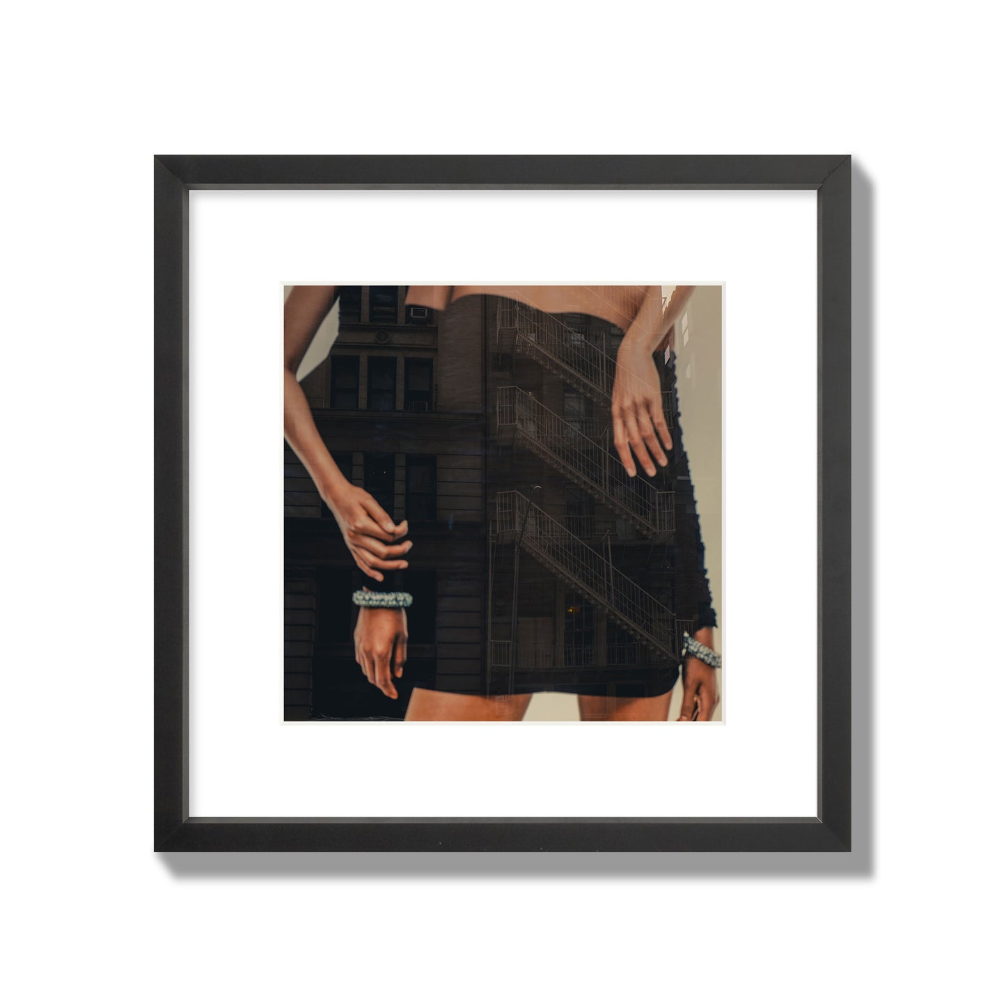 Fine art photograph of two women in black dresses, with the pattern of a fire escape reflected across the fabric, archival pigment print, medium size, black frame.