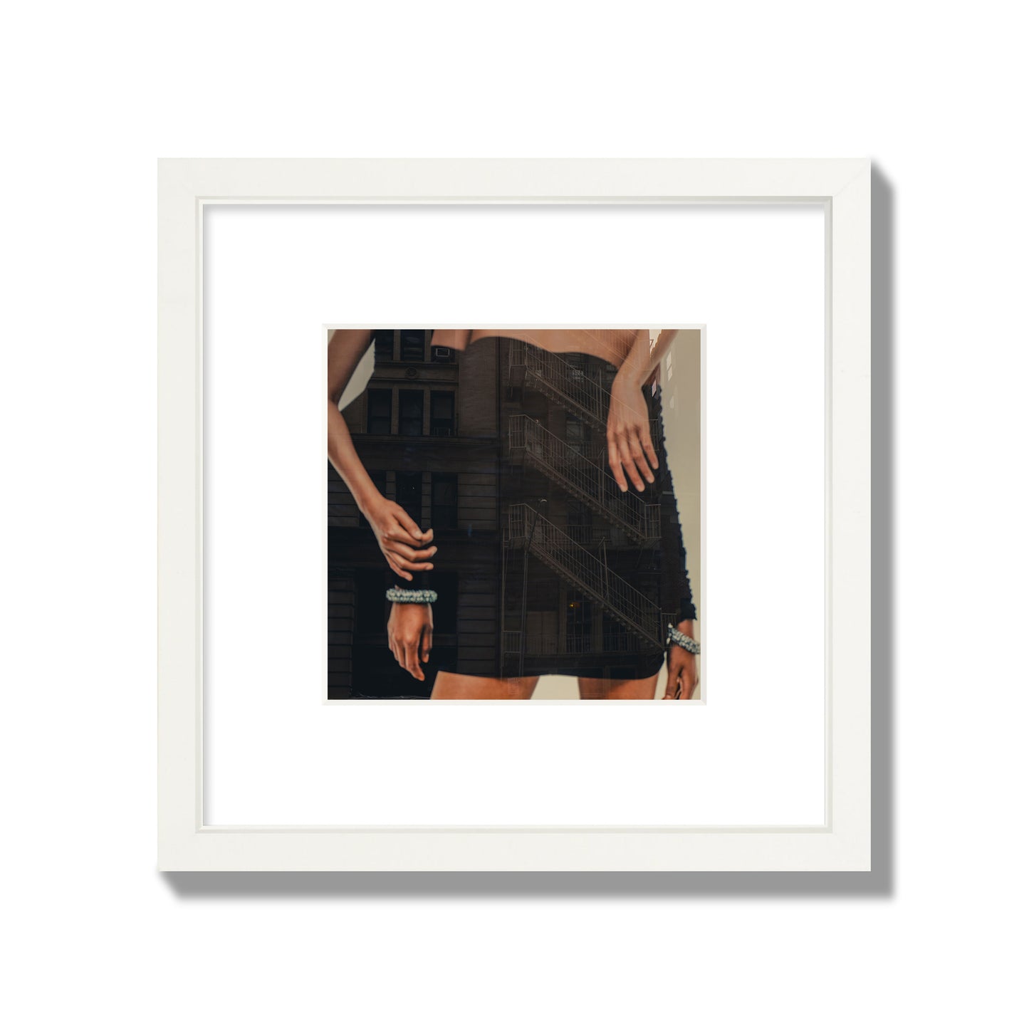 Fine art photograph of two women in black dresses, with the pattern of a fire escape reflected across the fabric, archival pigment print, small size, white frame.