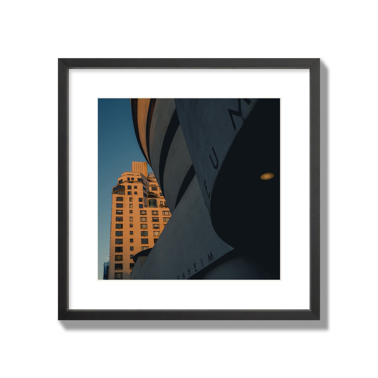Fine art photograph of the Guggenheim Museum at dusk, archival pigment print, large size, black frame.