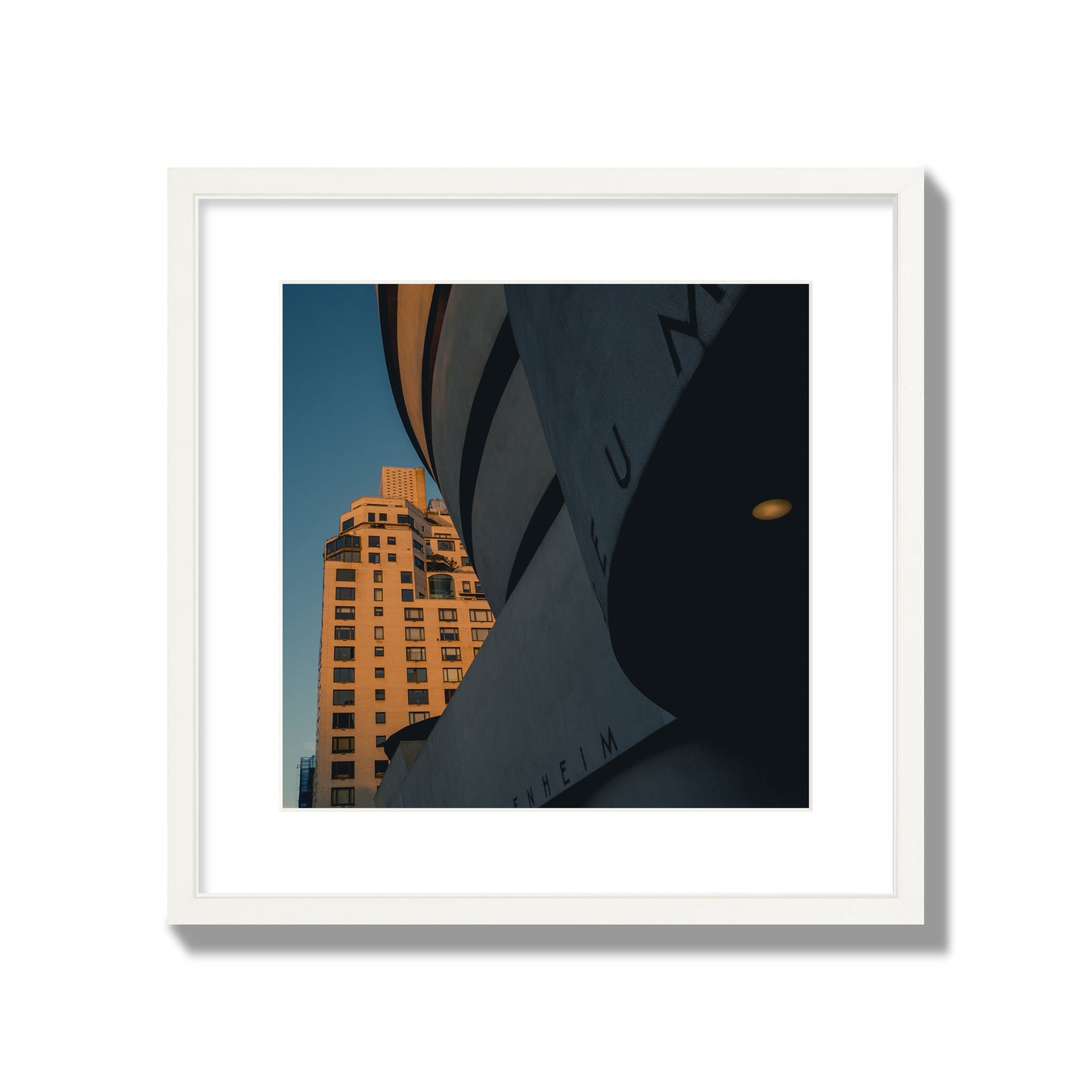 Fine art photograph of the Guggenheim Museum at dusk, archival pigment print, large size, white frame.
