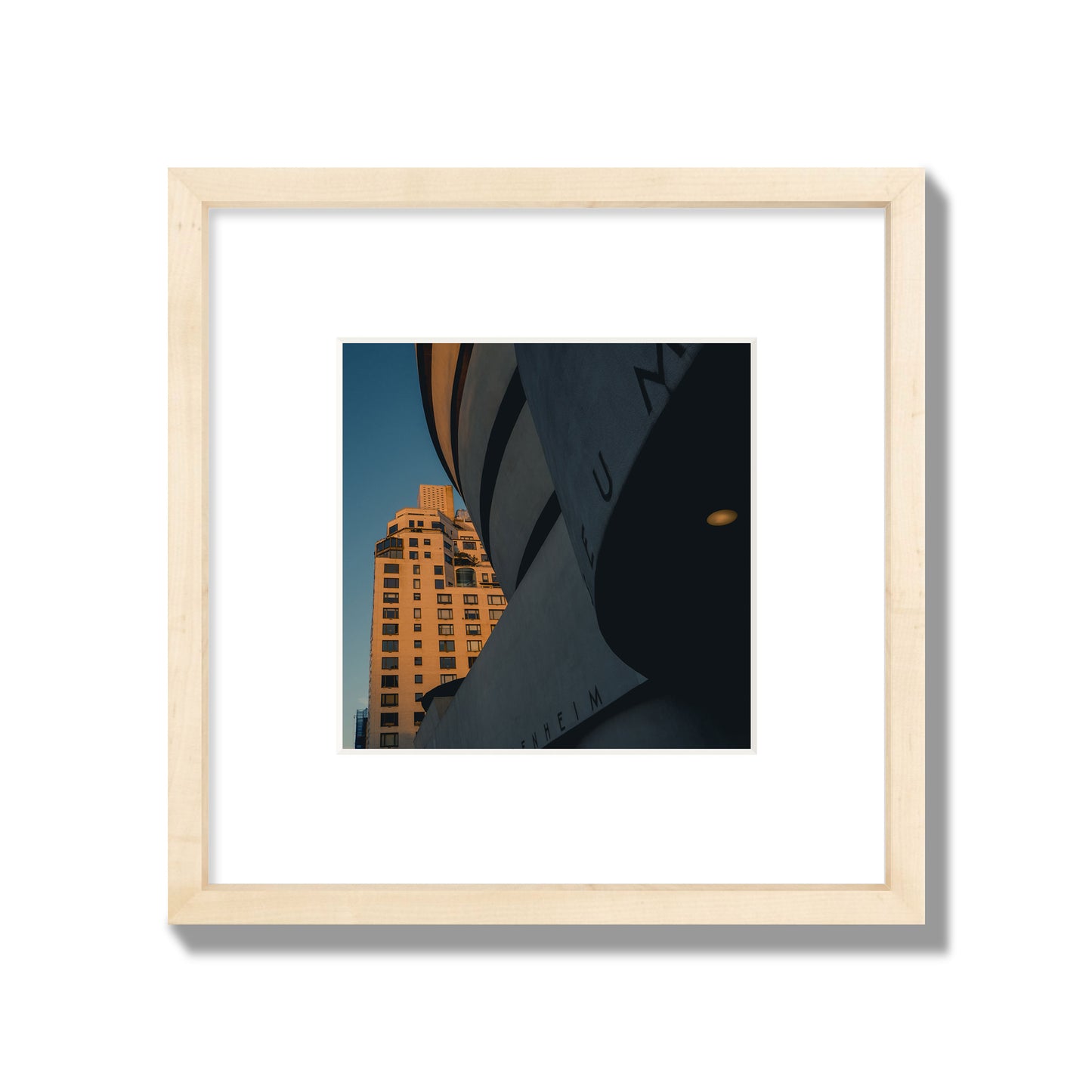 Fine art photograph of the Guggenheim Museum at dusk, archival pigment print, small size, natural wood frame.
