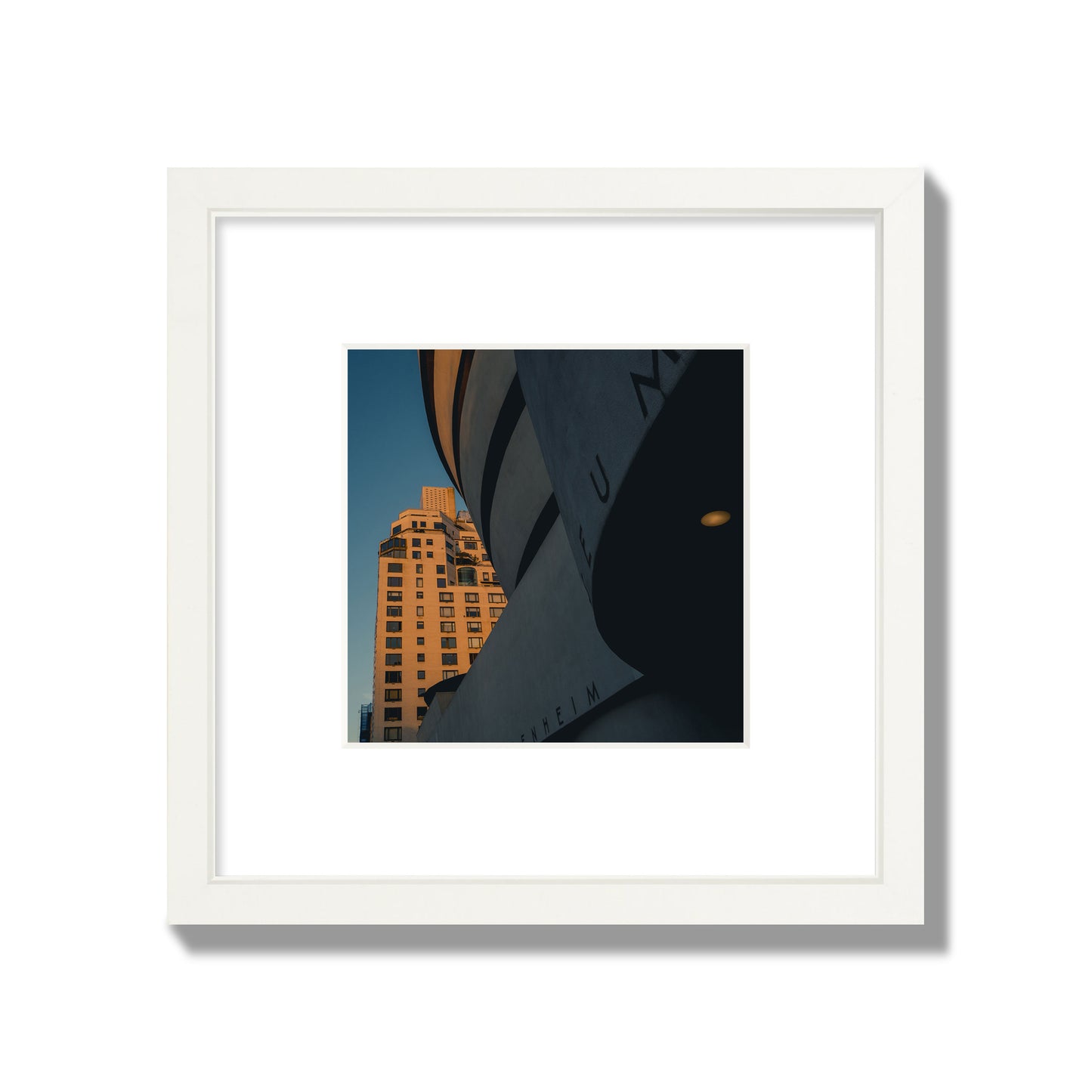 Fine art photograph of the Guggenheim Museum at dusk, archival pigment print, small size, white frame.