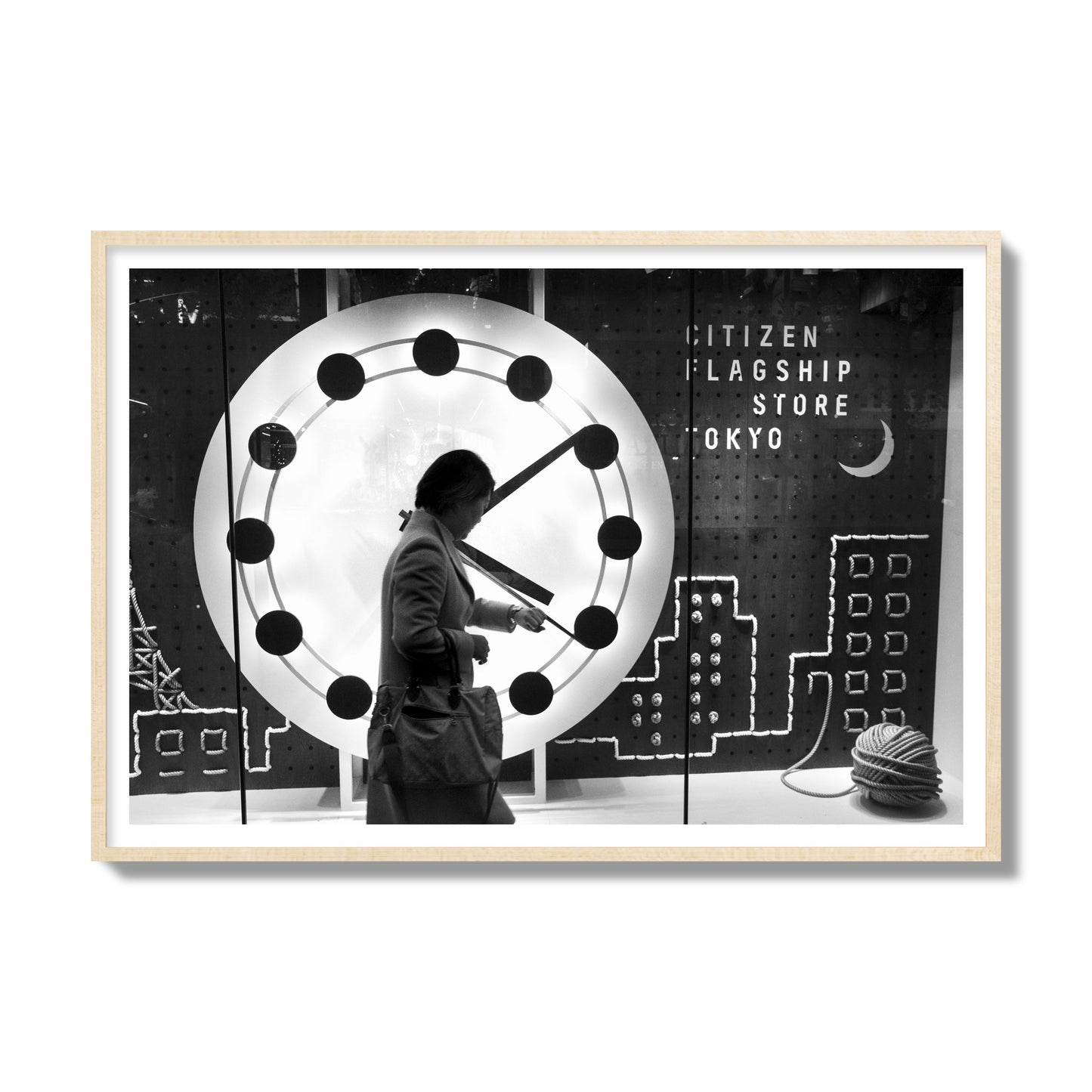 Fine art street photograph of a woman checking her watch as she walks past a giant clock on a busy Tokyo city street. Archival pigment print, gallery size, natural wood frame.