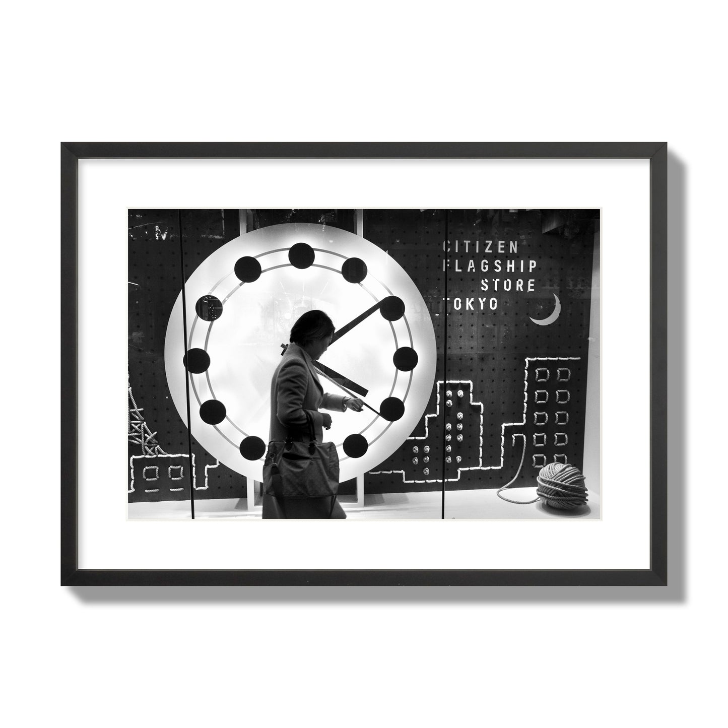 Fine art street photograph of a woman checking her watch as she walks past a giant clock on a busy Tokyo city street. Archival pigment print, large size, black frame.