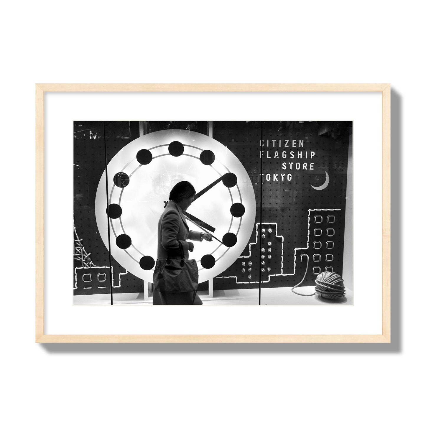 Fine art street photograph of a woman checking her watch as she walks past a giant clock on a busy Tokyo city street. Archival pigment print, large size, natural wood frame.