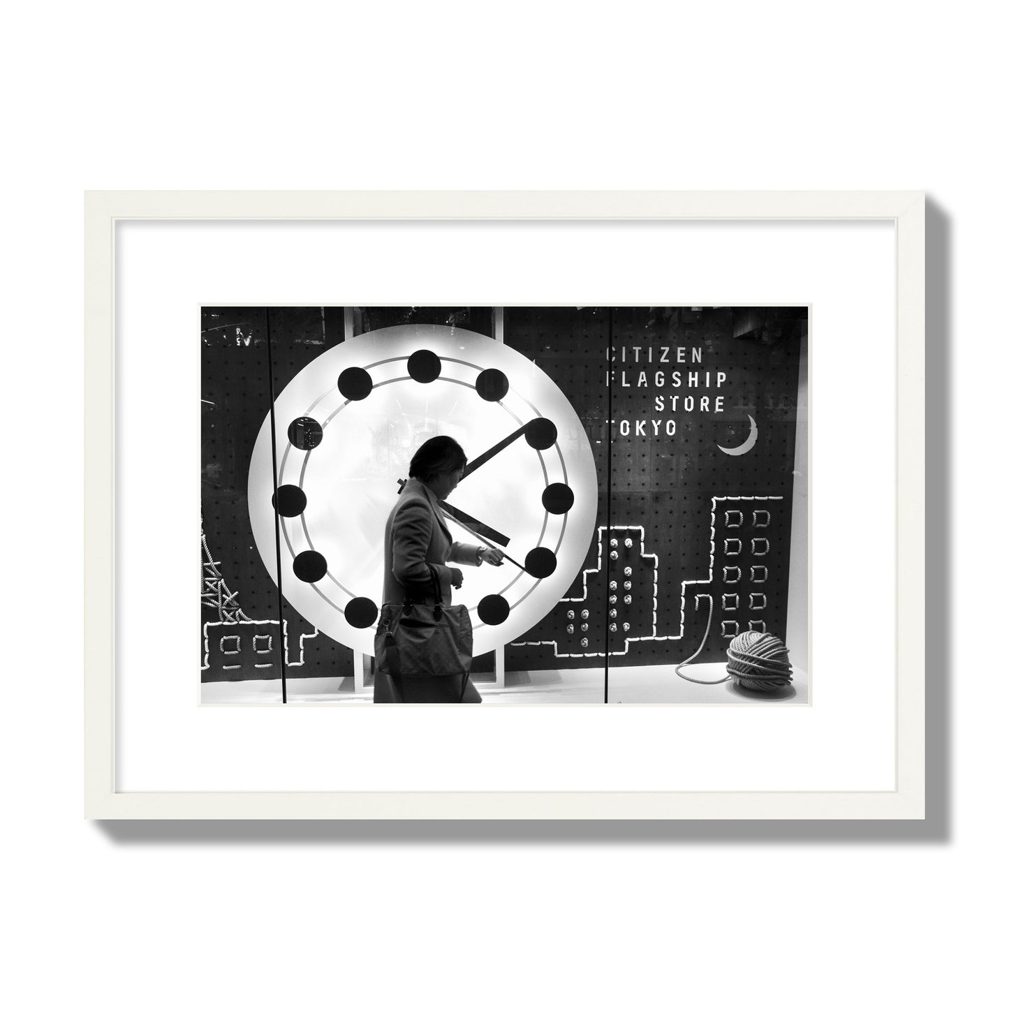 Fine art street photograph of a woman checking her watch as she walks past a giant clock on a busy Tokyo city street. Archival pigment print, medium size, white frame.