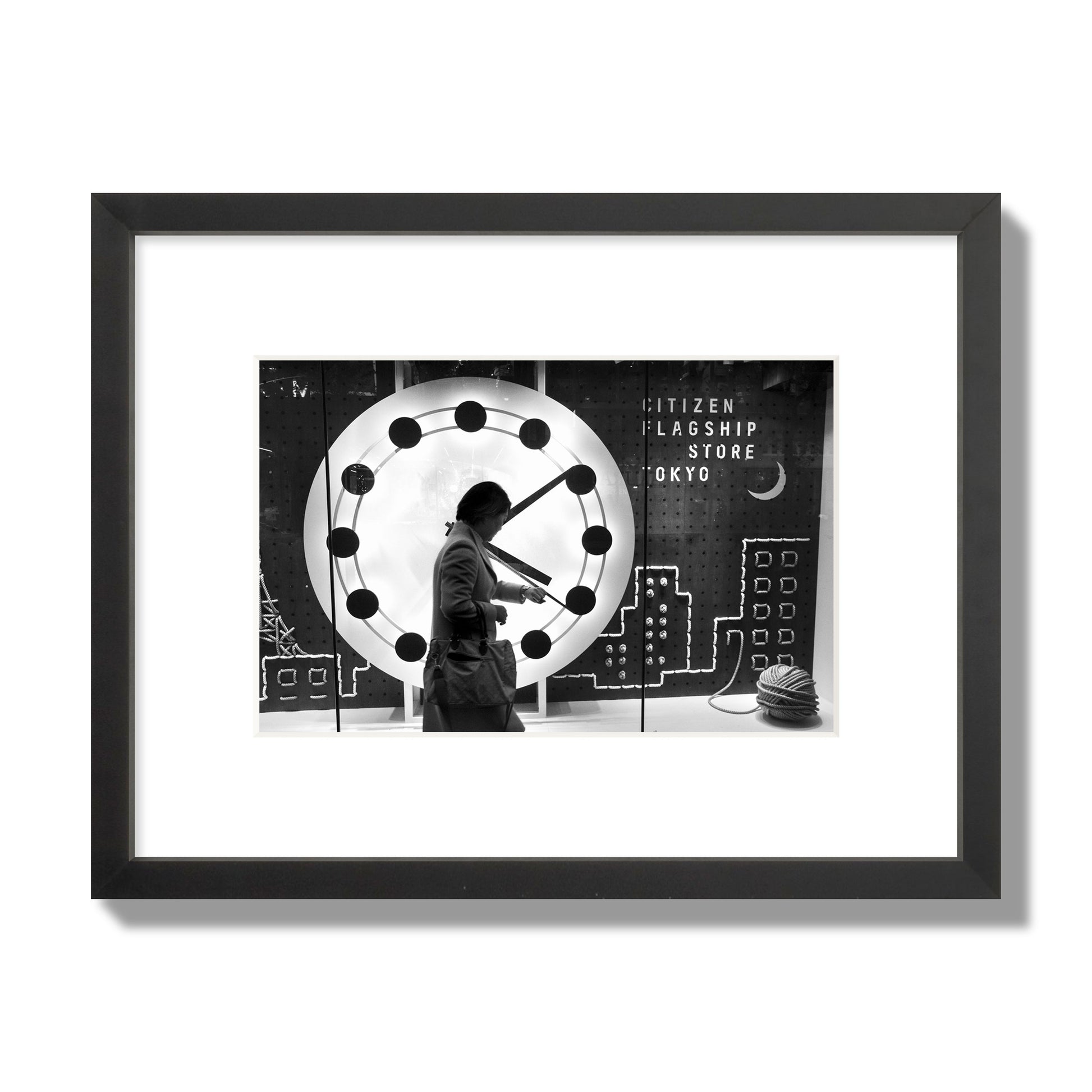 Fine art street photograph of a woman checking her watch as she walks past a giant clock on a busy Tokyo city street. Archival pigment print, small size, black frame.