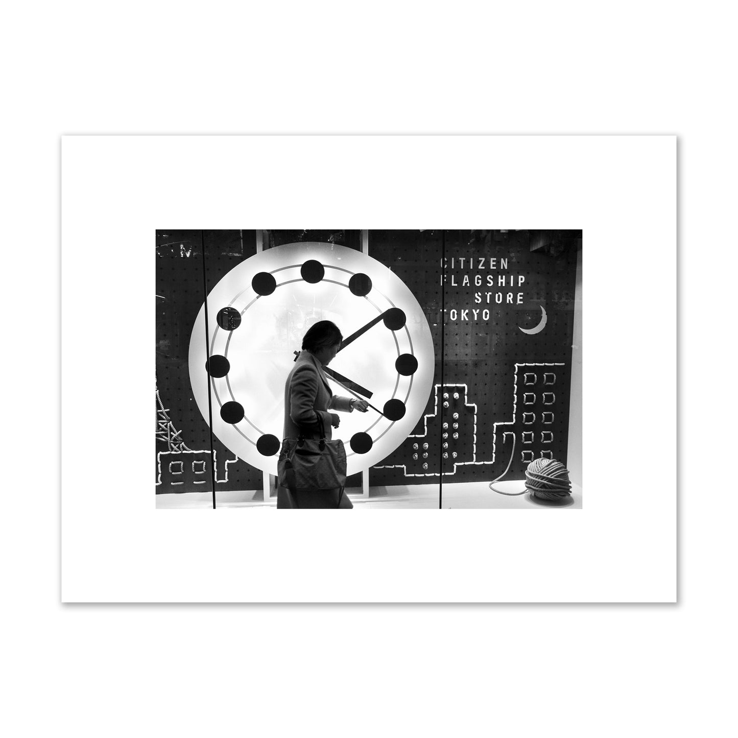 Fine art street photograph of a woman checking her watch as she walks past a giant clock on a busy Tokyo city street. Archival pigment print, small size, unframed.