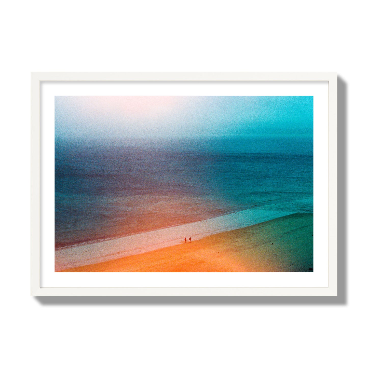 Fine art street photograph of a serene beach with two figures walking in the distance, captured in a dreamlike composition with soft orange and blue hues. Archival pigment print, giant size, white frame.