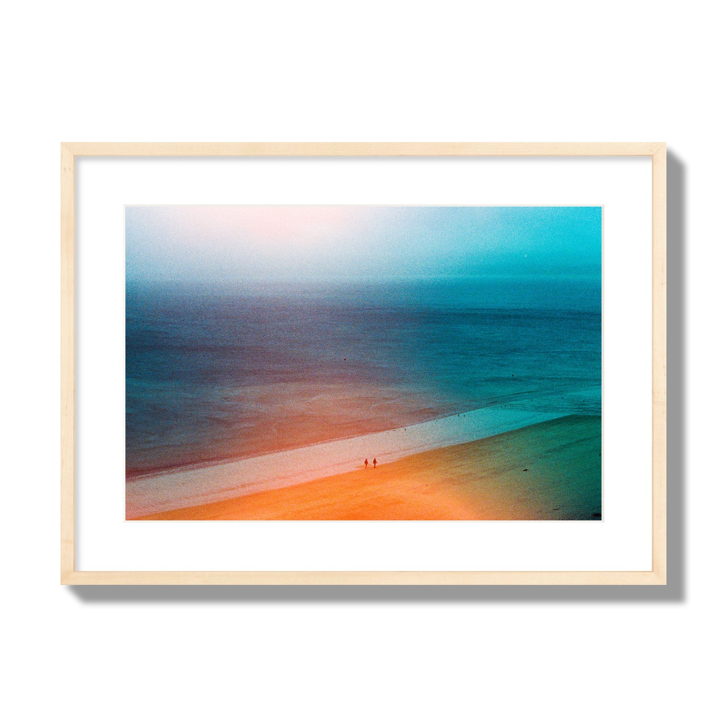 Fine art street photograph of a serene beach with two figures walking in the distance, captured in a dreamlike composition with soft orange and blue hues. Archival pigment print, large size, natural wood frame.