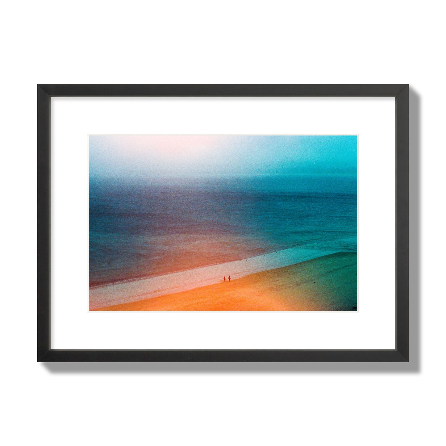 Fine art street photograph of a serene beach with two figures walking in the distance, captured in a dreamlike composition with soft orange and blue hues. Archival pigment print, medium size, black frame.
