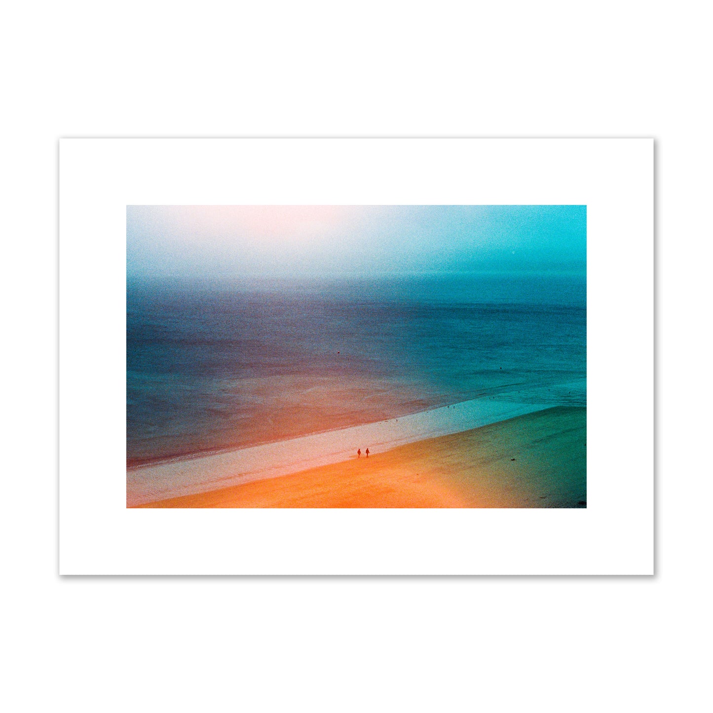 Fine art street photograph of a serene beach with two figures walking in the distance, captured in a dreamlike composition with soft orange and blue hues. Archival pigment print, medium size, unframed.