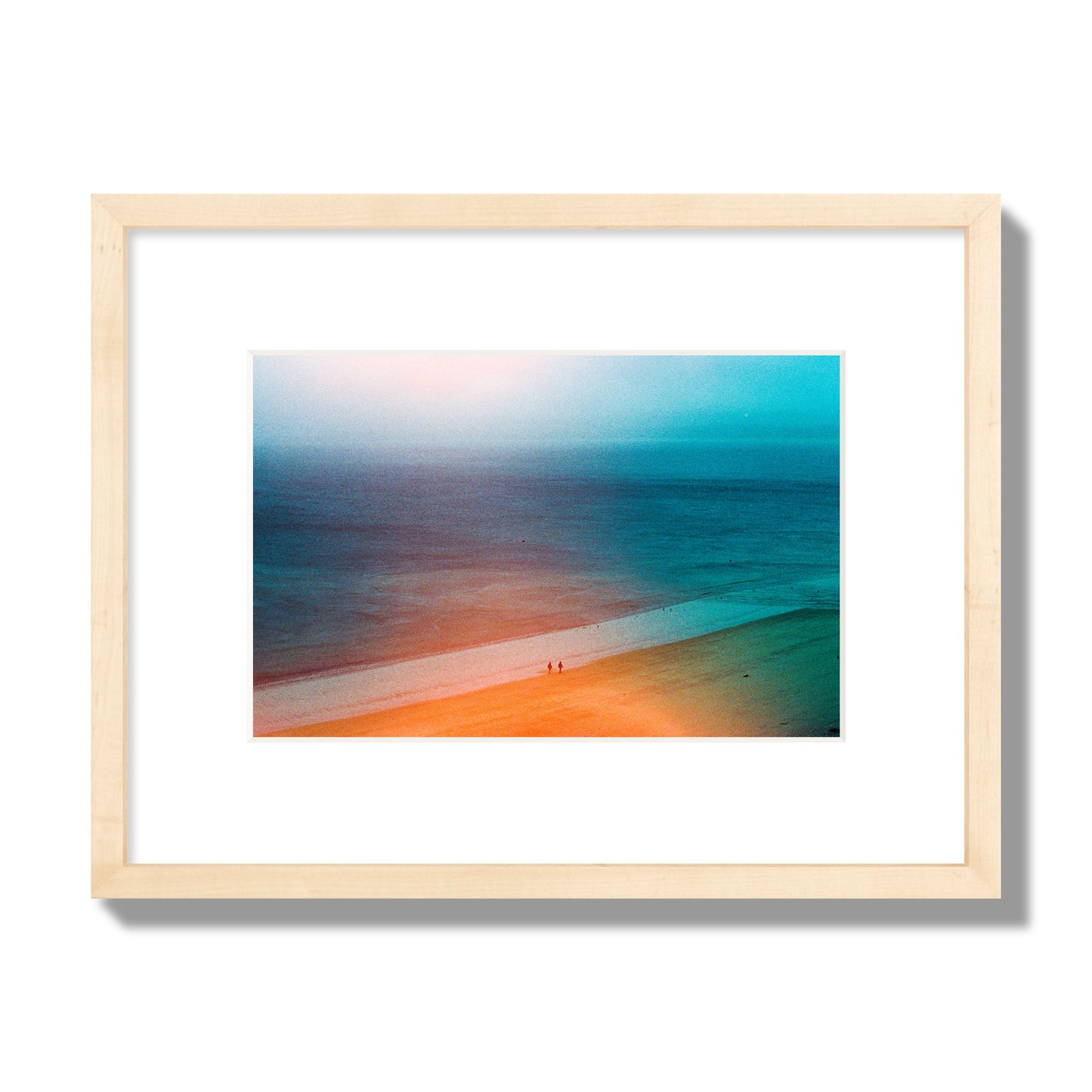 Fine art street photograph of a serene beach with two figures walking in the distance, captured in a dreamlike composition with soft orange and blue hues. Archival pigment print, small size, natural wood frame.