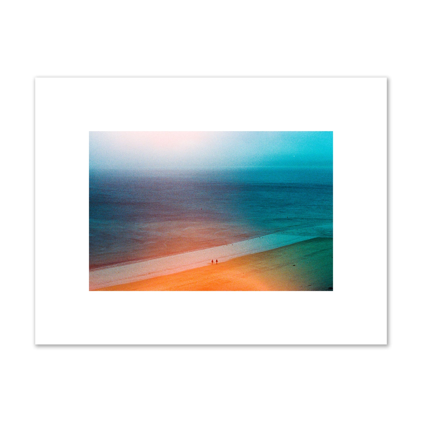 Fine art street photograph of a serene beach with two figures walking in the distance, captured in a dreamlike composition with soft orange and blue hues. Archival pigment print, small size, unframed.