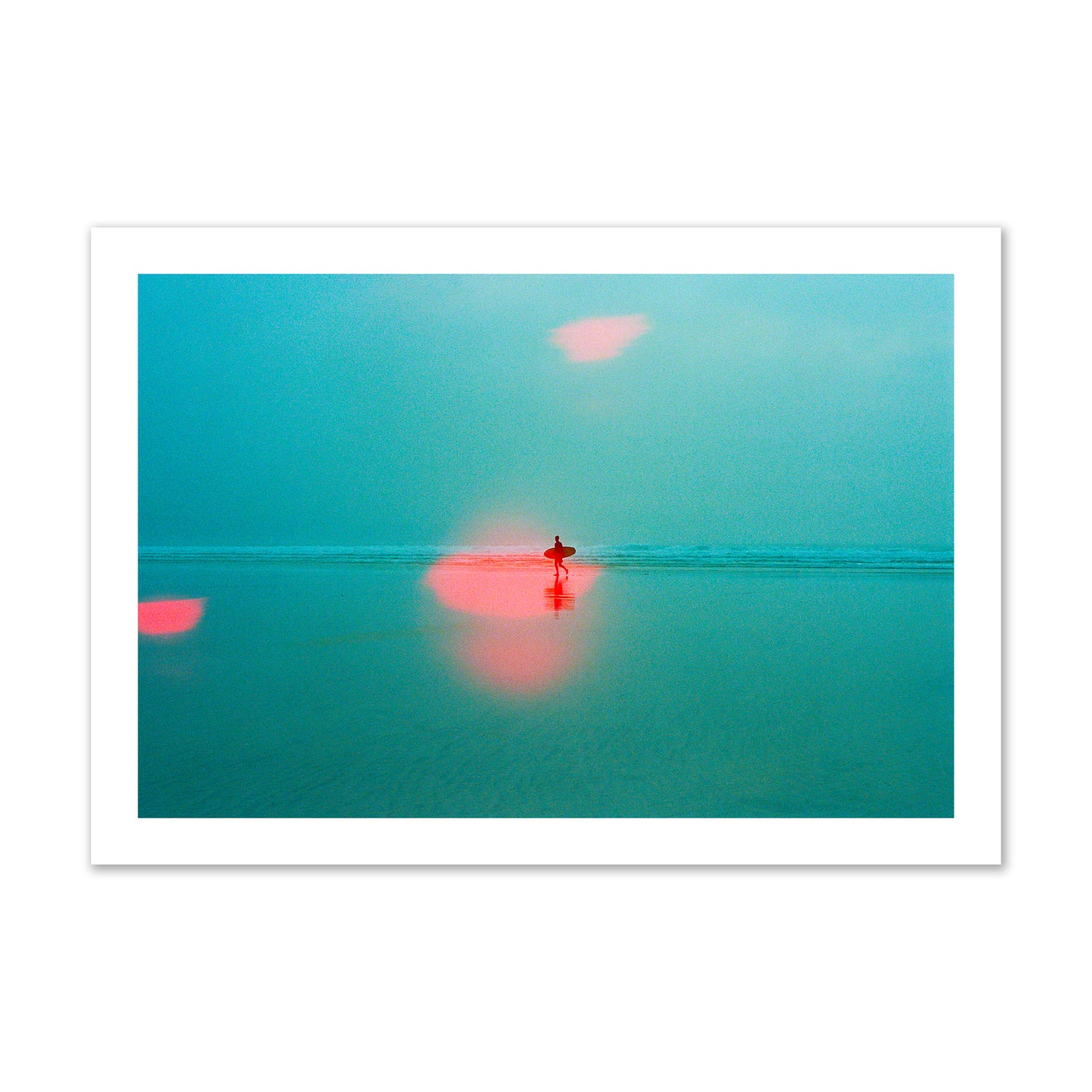 Fine art street photograph of a tranquil beach with a surfer running toward the waves, featuring a dreamlike composition with soft teal tones and a striking red lens flare. Archival pigment print, collector size, unframed.