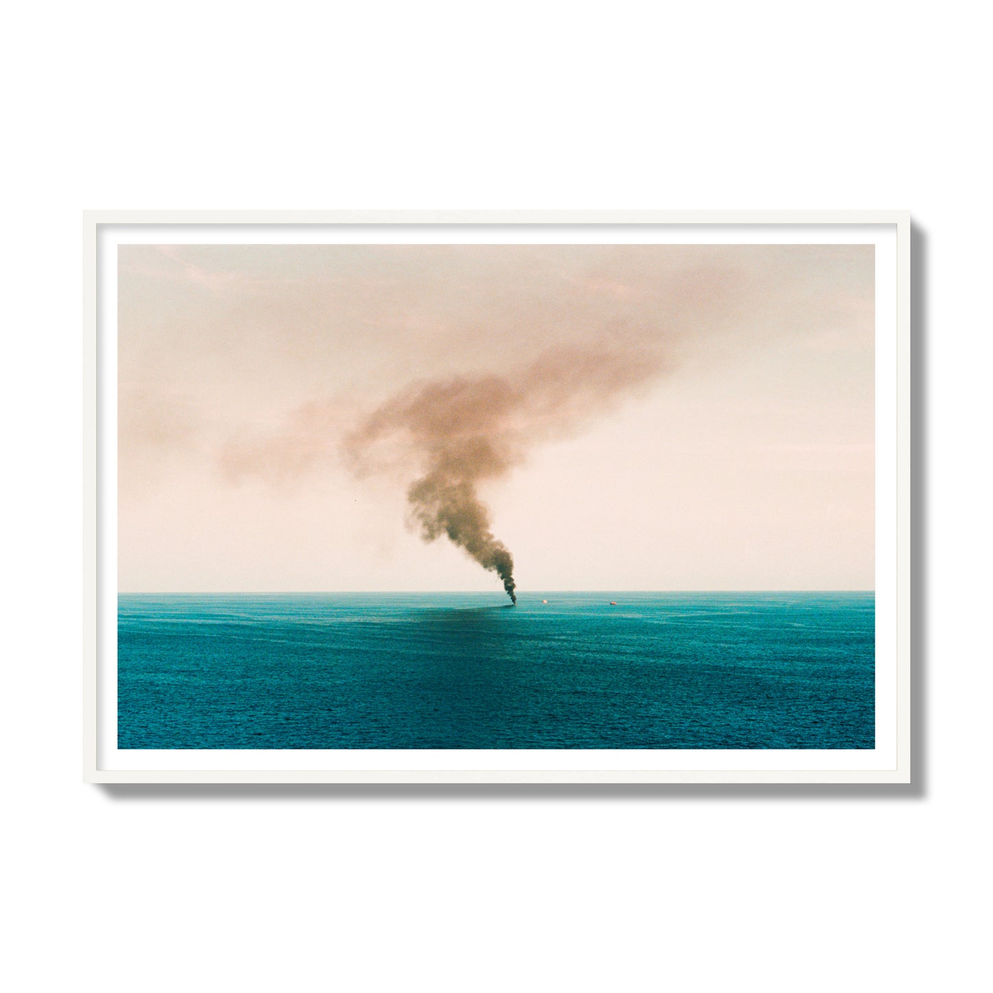 Fine art street photograph of a moody seascape with smoke rising from a distant boat, capturing a sense of mystery and atmosphere. Archival pigment print, gallery size, white frame.