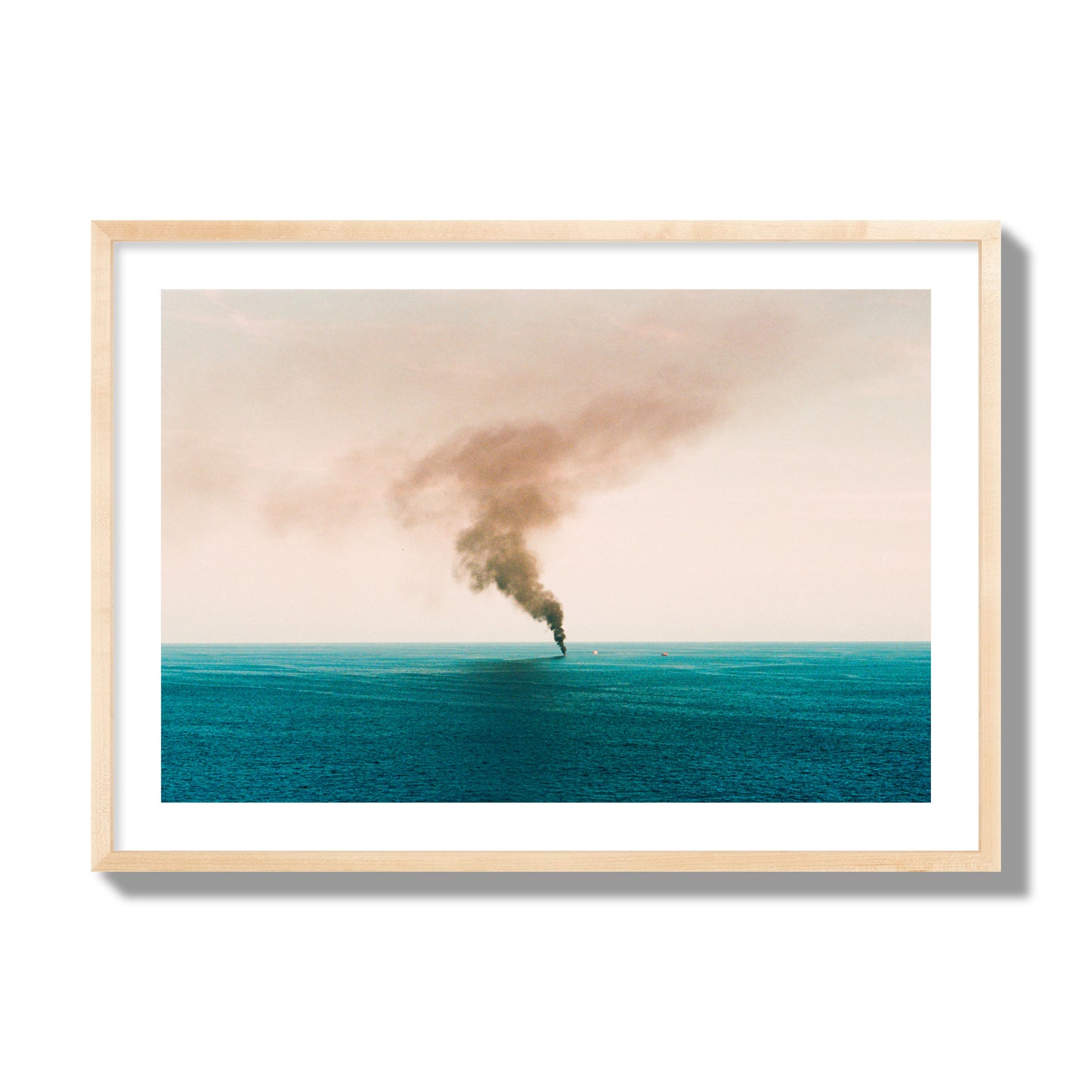 Fine art street photograph of a moody seascape with smoke rising from a distant boat, capturing a sense of mystery and atmosphere. Archival pigment print, giant size, natural wood frame.