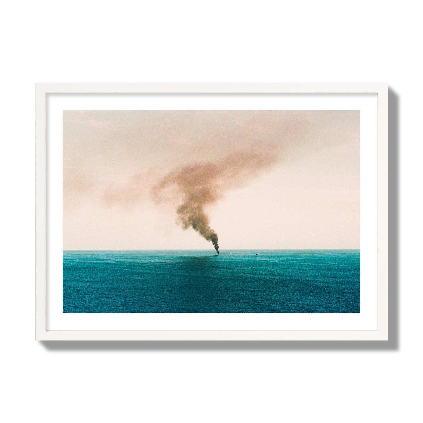 Fine art street photograph of a moody seascape with smoke rising from a distant boat, capturing a sense of mystery and atmosphere. Archival pigment print, giant size, white frame.