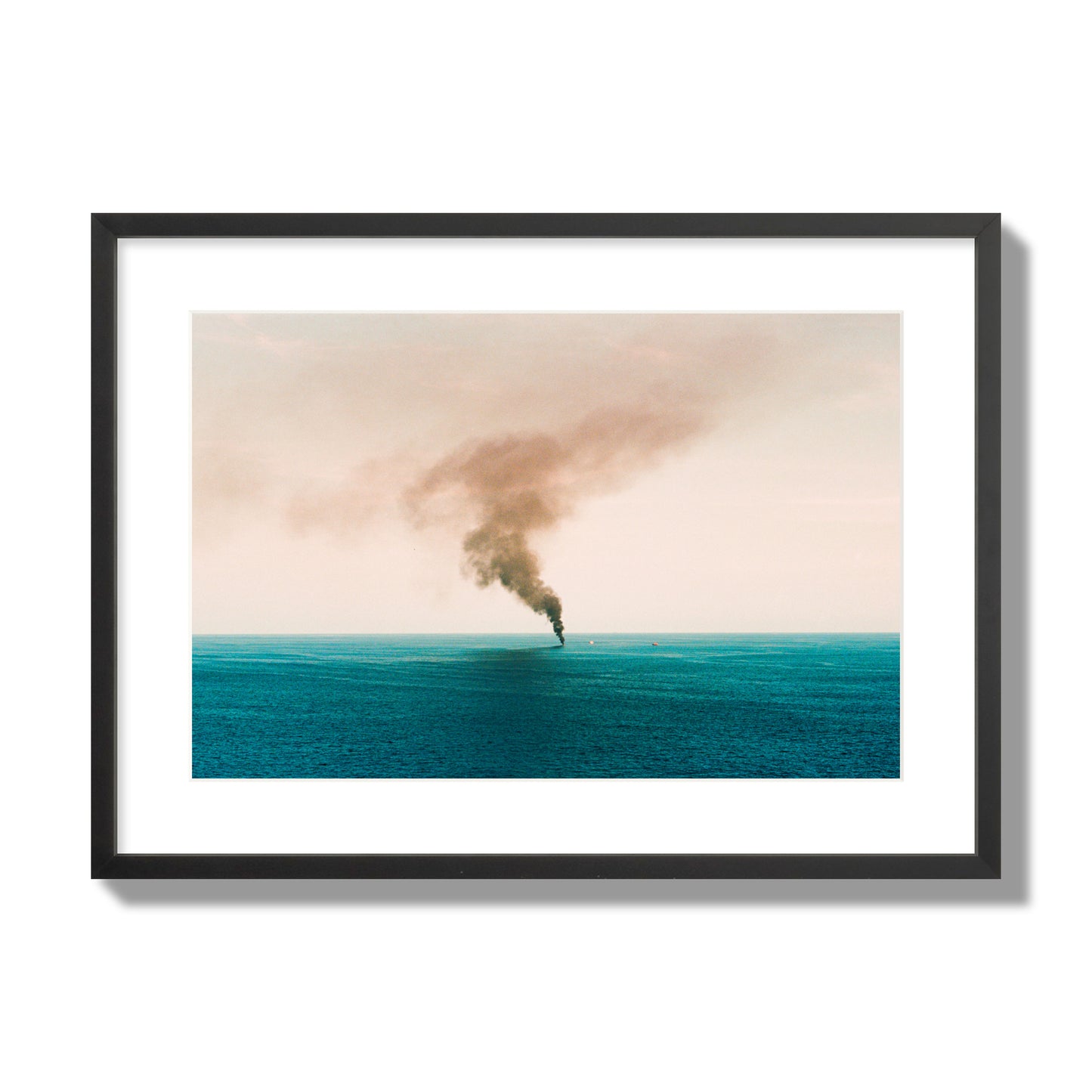 Fine art street photograph of a moody seascape with smoke rising from a distant boat, capturing a sense of mystery and atmosphere. Archival pigment print, large size, black frame.