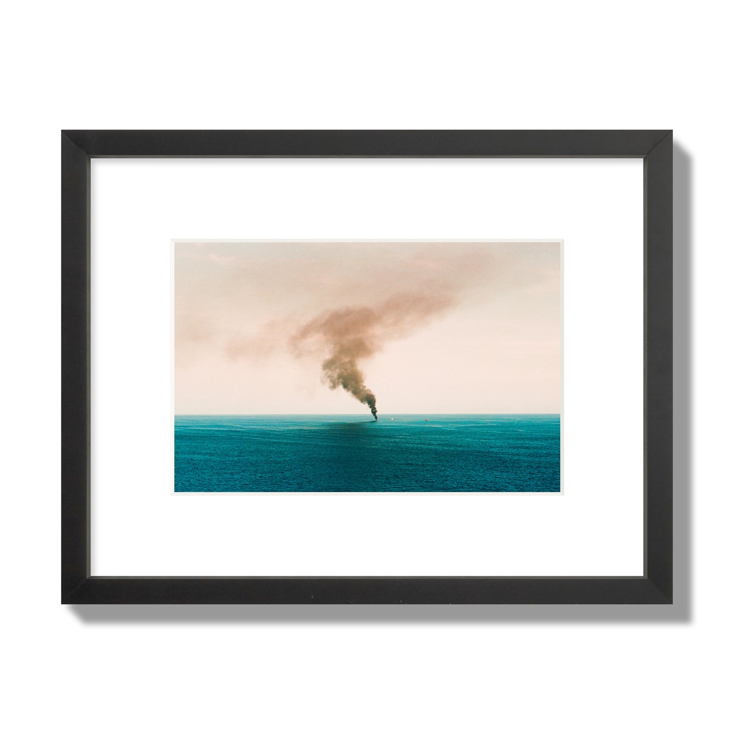 Fine art street photograph of a moody seascape with smoke rising from a distant boat, capturing a sense of mystery and atmosphere. Archival pigment print, small size, black frame.