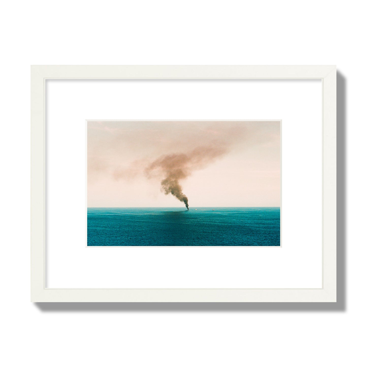 Fine art street photograph of a moody seascape with smoke rising from a distant boat, capturing a sense of mystery and atmosphere. Archival pigment print, small size, white frame.