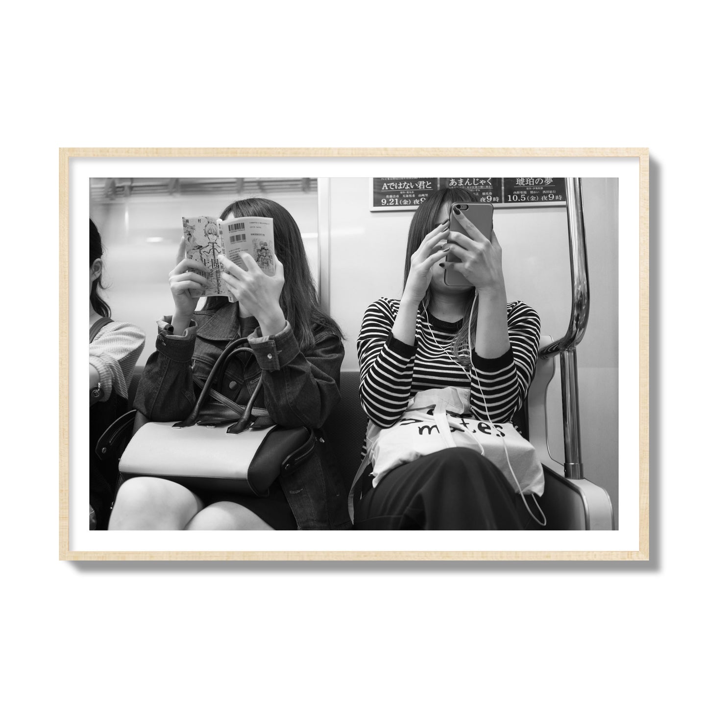 Black and white fine art photograph of two women on the Tokyo Metro, archival pigment print, collector size, natural wood frame