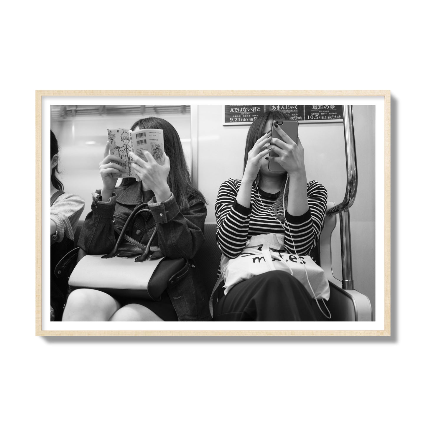 Black and white fine art photograph of two women on the Tokyo Metro, archival pigment print, gallery size, natural wood frame