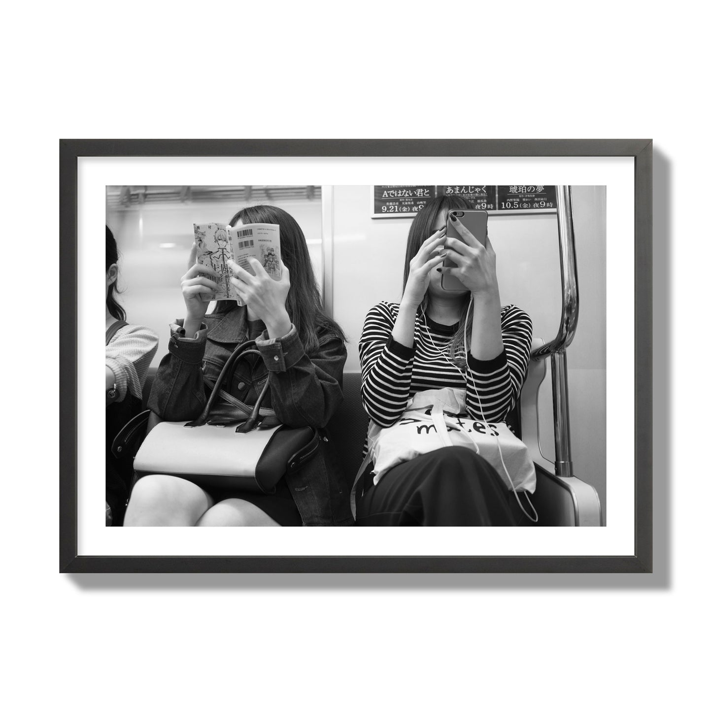 Black and white fine art photograph of two women on the Tokyo Metro, archival pigment print, giant size, black frame