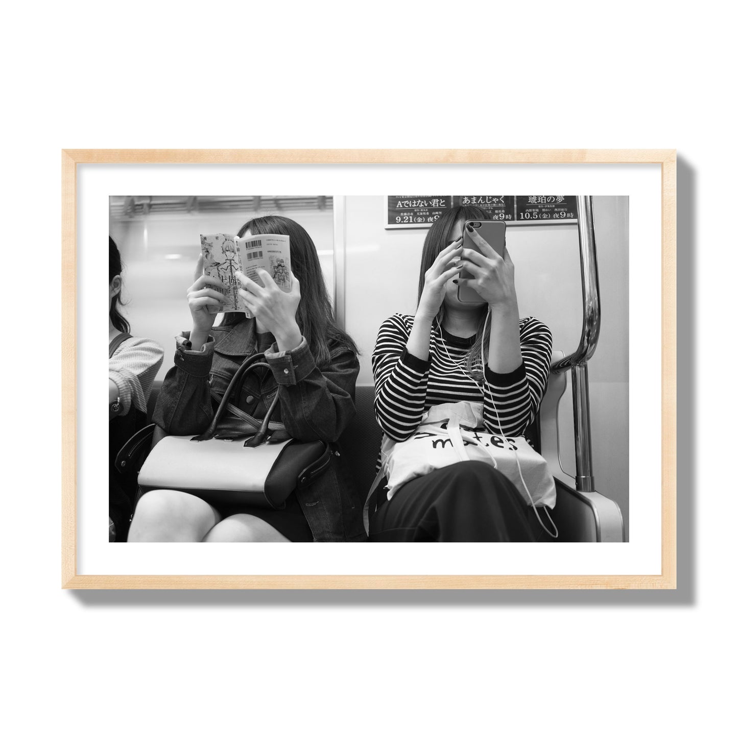 Black and white fine art photograph of two women on the Tokyo Metro, archival pigment print, giant size, natural wood frame