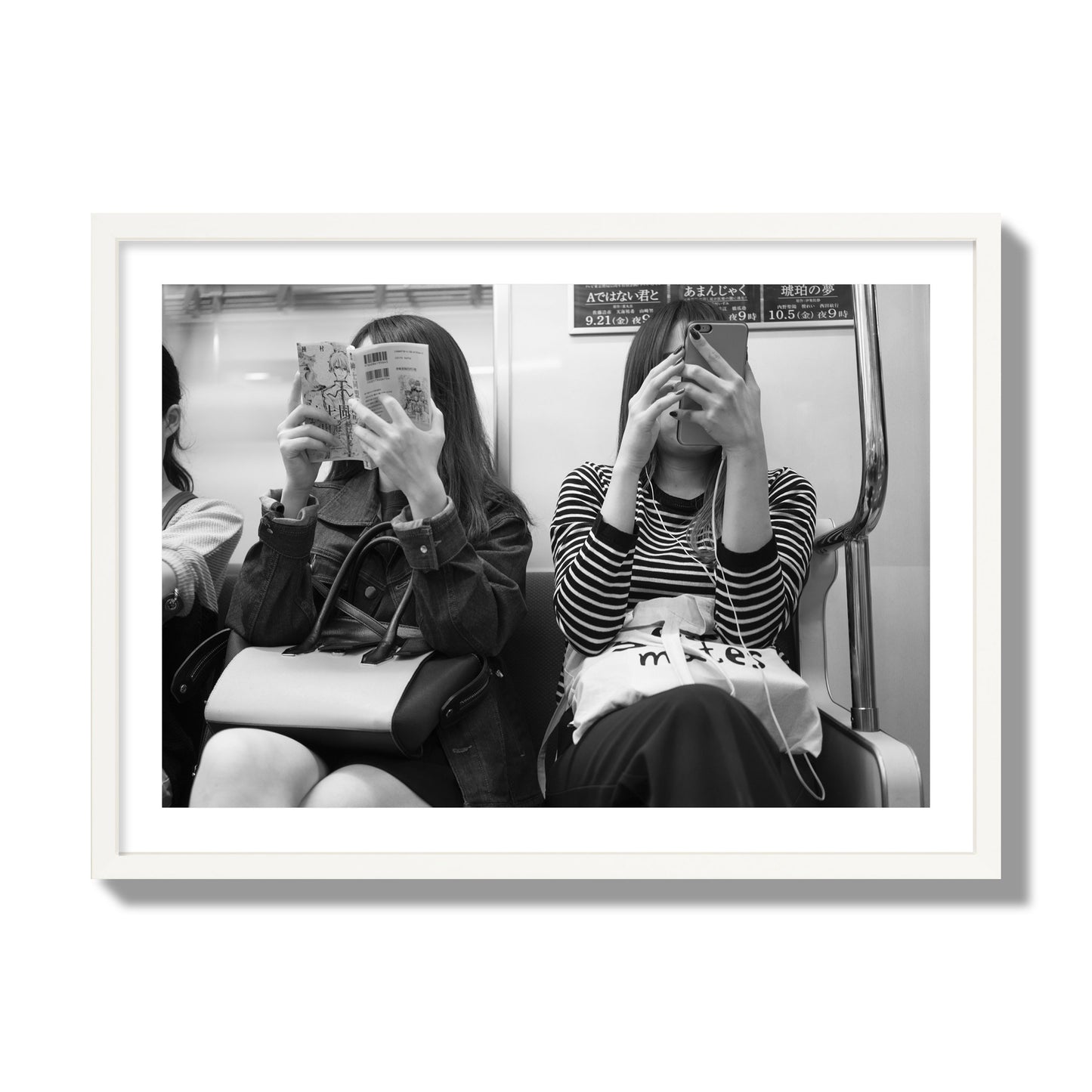 Black and white fine art photograph of two women on the Tokyo Metro, archival pigment print, giant size, white frame
