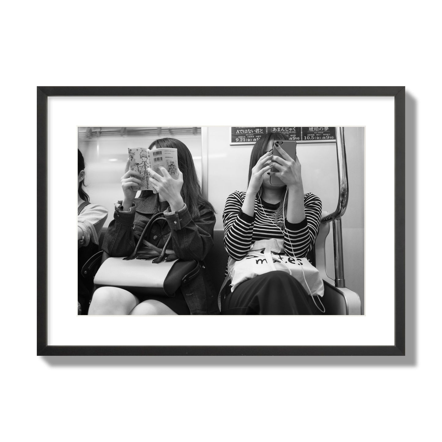 Black and white fine art photograph of two women on the Tokyo Metro, archival pigment print, large size, black frame