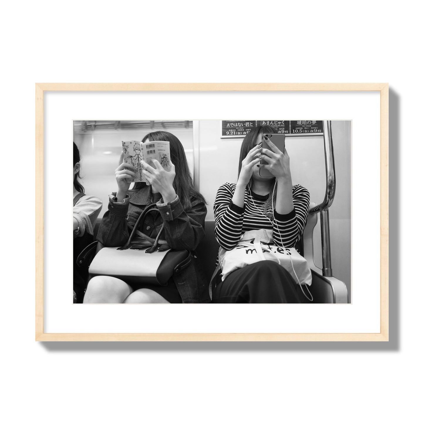 Black and white fine art photograph of two women on the Tokyo Metro, archival pigment print, large size, natural wood frame