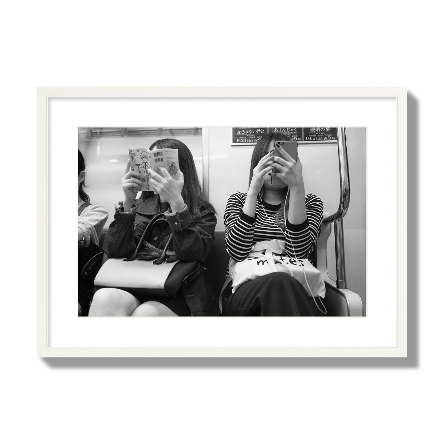 Black and white fine art photograph of two women on the Tokyo Metro, archival pigment print, large size, white frame