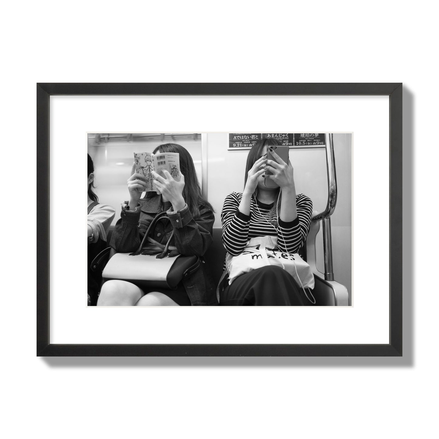 Black and white fine art photograph of two women on the Tokyo Metro, archival pigment print, medium size, black frame