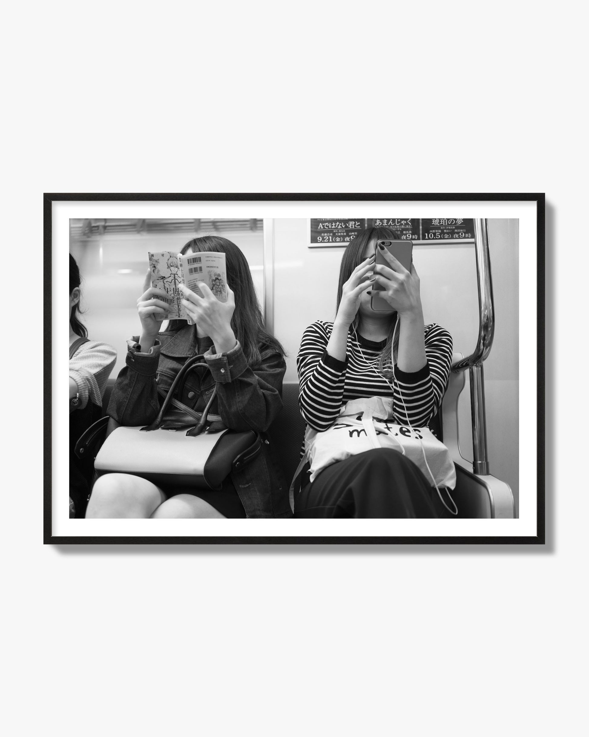 Black and white fine art photograph of two women on the Tokyo Metro, archival pigment print, black frame