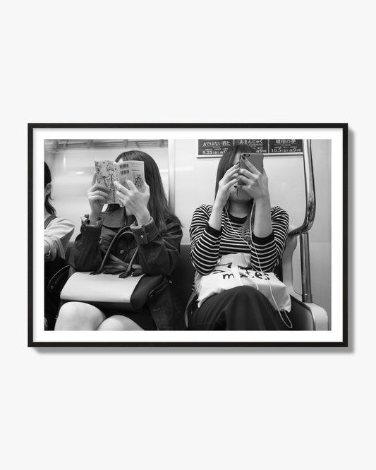 Black and white fine art photograph of two women on the Tokyo Metro, archival pigment print, black frame