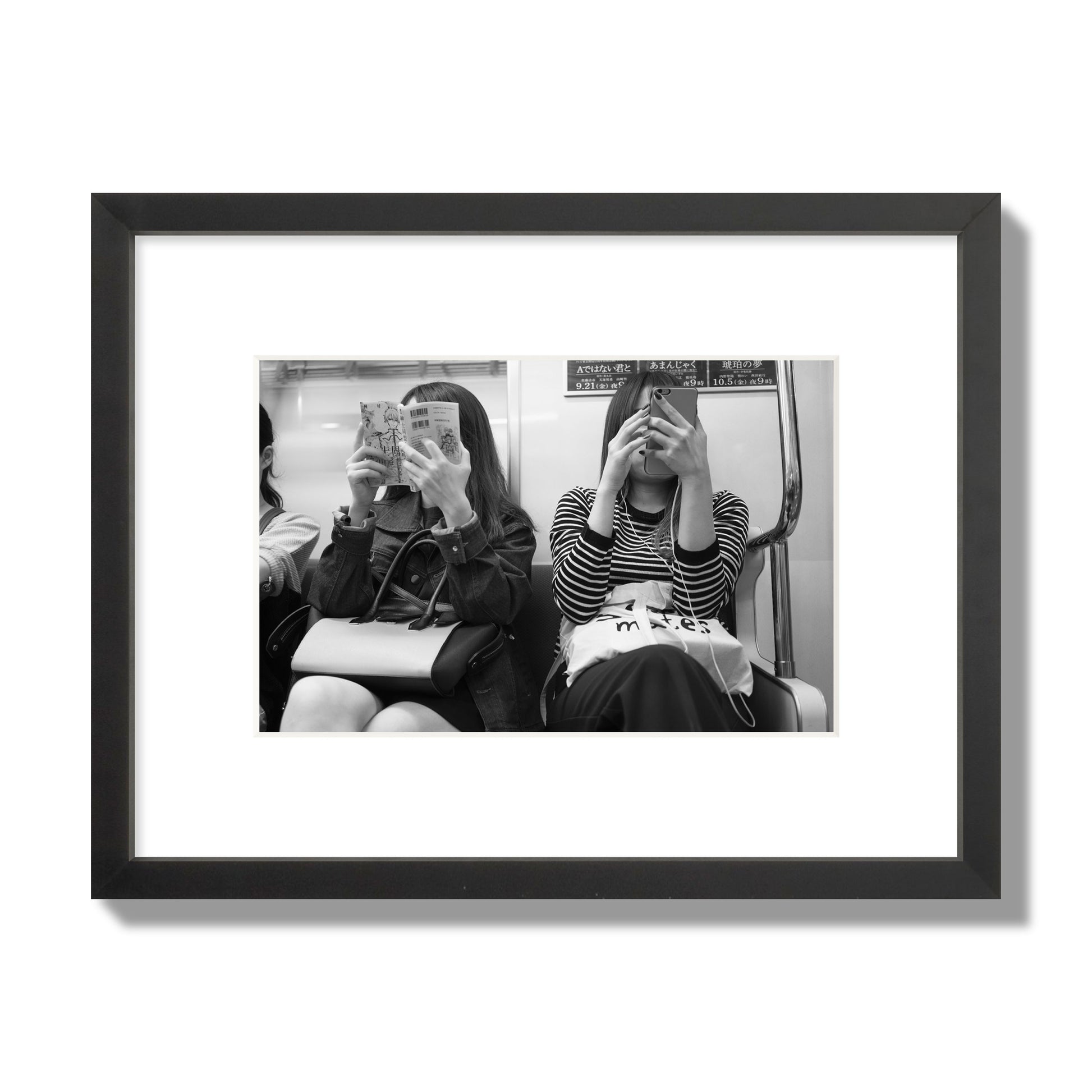 Black and white fine art photograph of two women on the Tokyo Metro, archival pigment print, small size, black frame