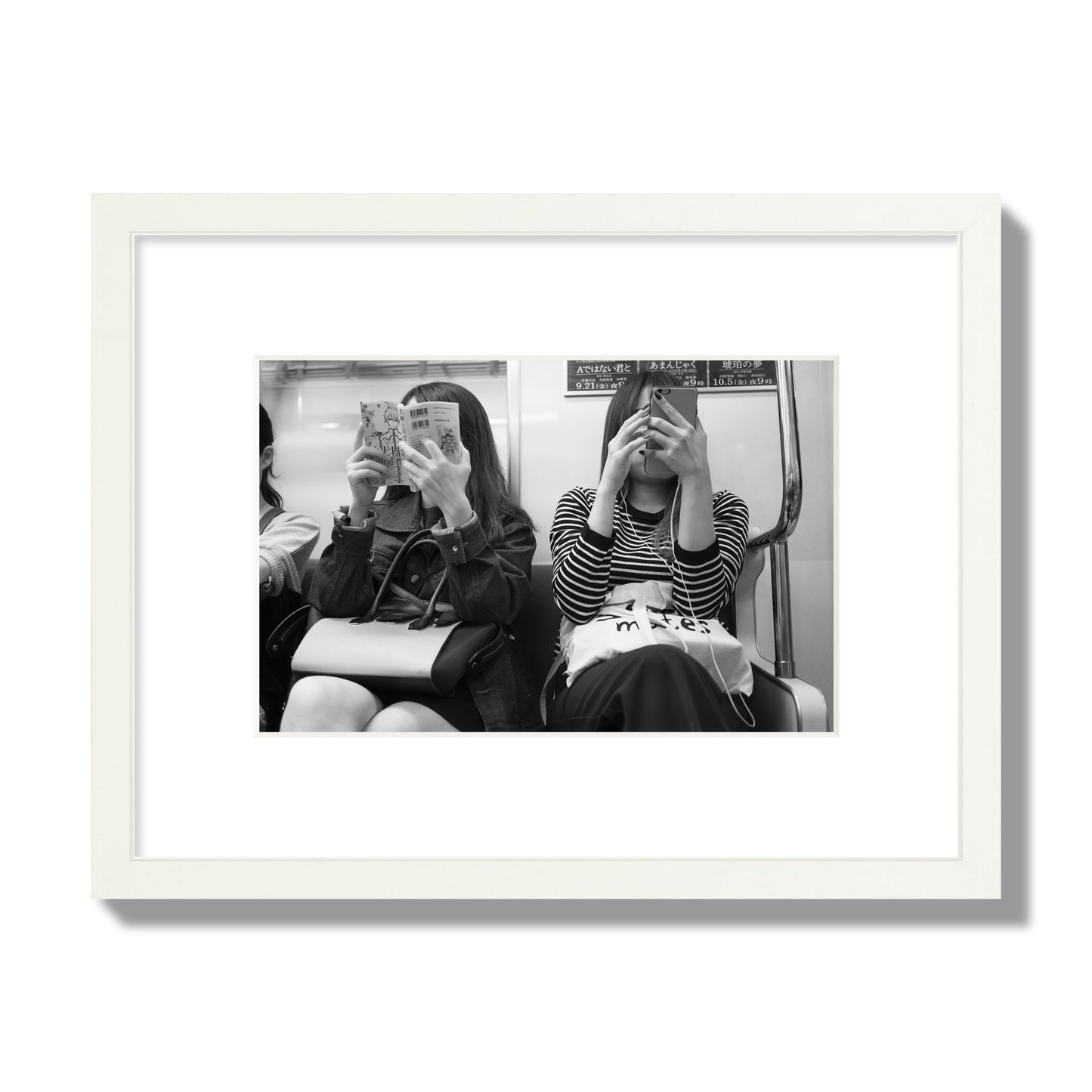 Black and white fine art photograph of two women on the Tokyo Metro, archival pigment print, small size, white frame