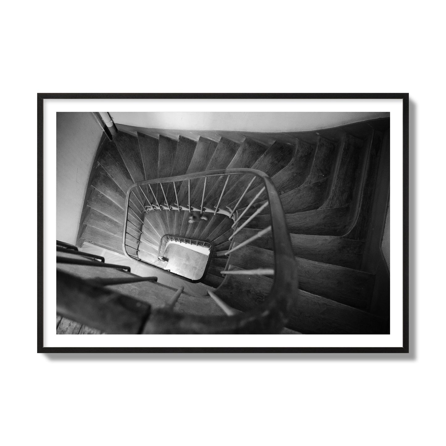 Fine art street photograph of a person walking down a staircase in Paris, France, archival pigment print, collector size, black frame