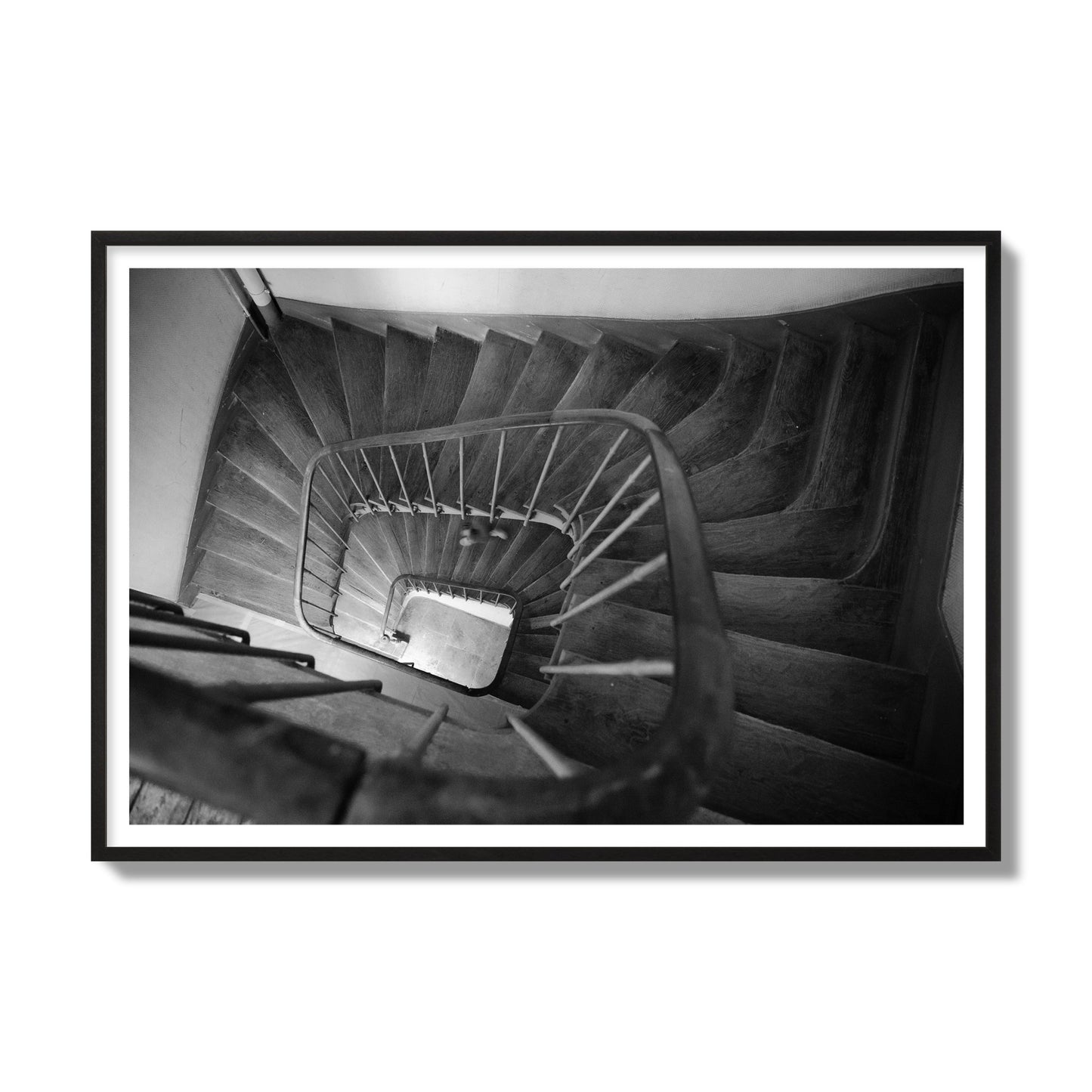 Fine art street photograph of a person walking down a staircase in Paris, France, archival pigment print, gallery size, black frame
