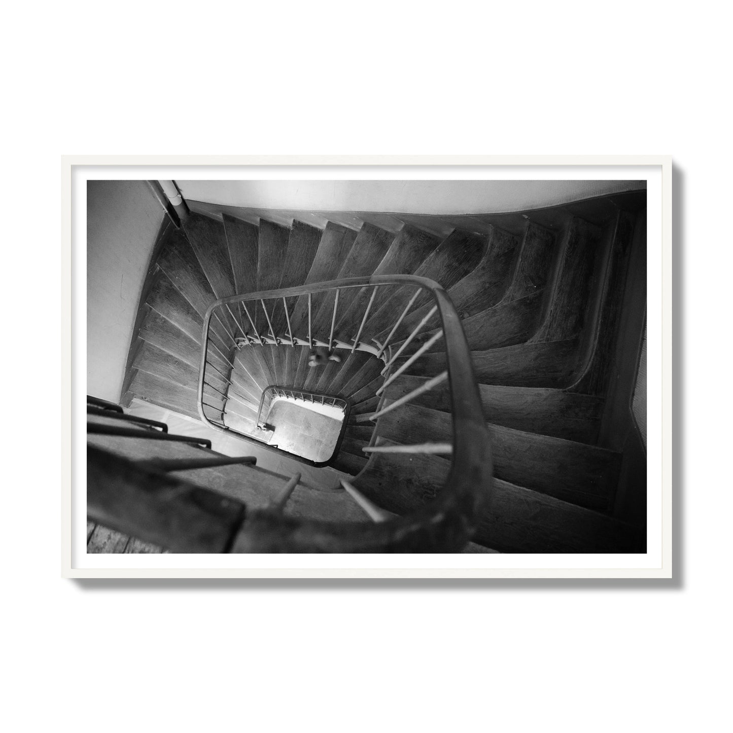 Fine art street photograph of a person walking down a staircase in Paris, France, archival pigment print, gallery size, white frame