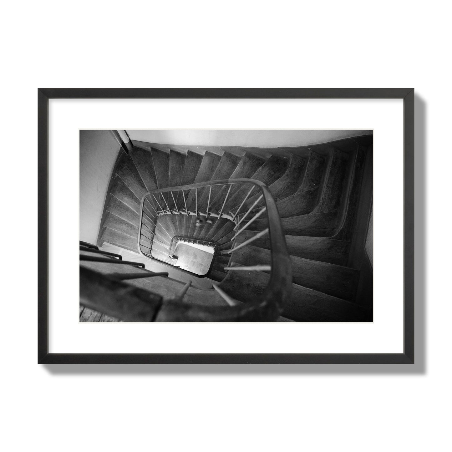 Fine art street photograph of a person walking down a staircase in Paris, France, archival pigment print, large size, black frame
