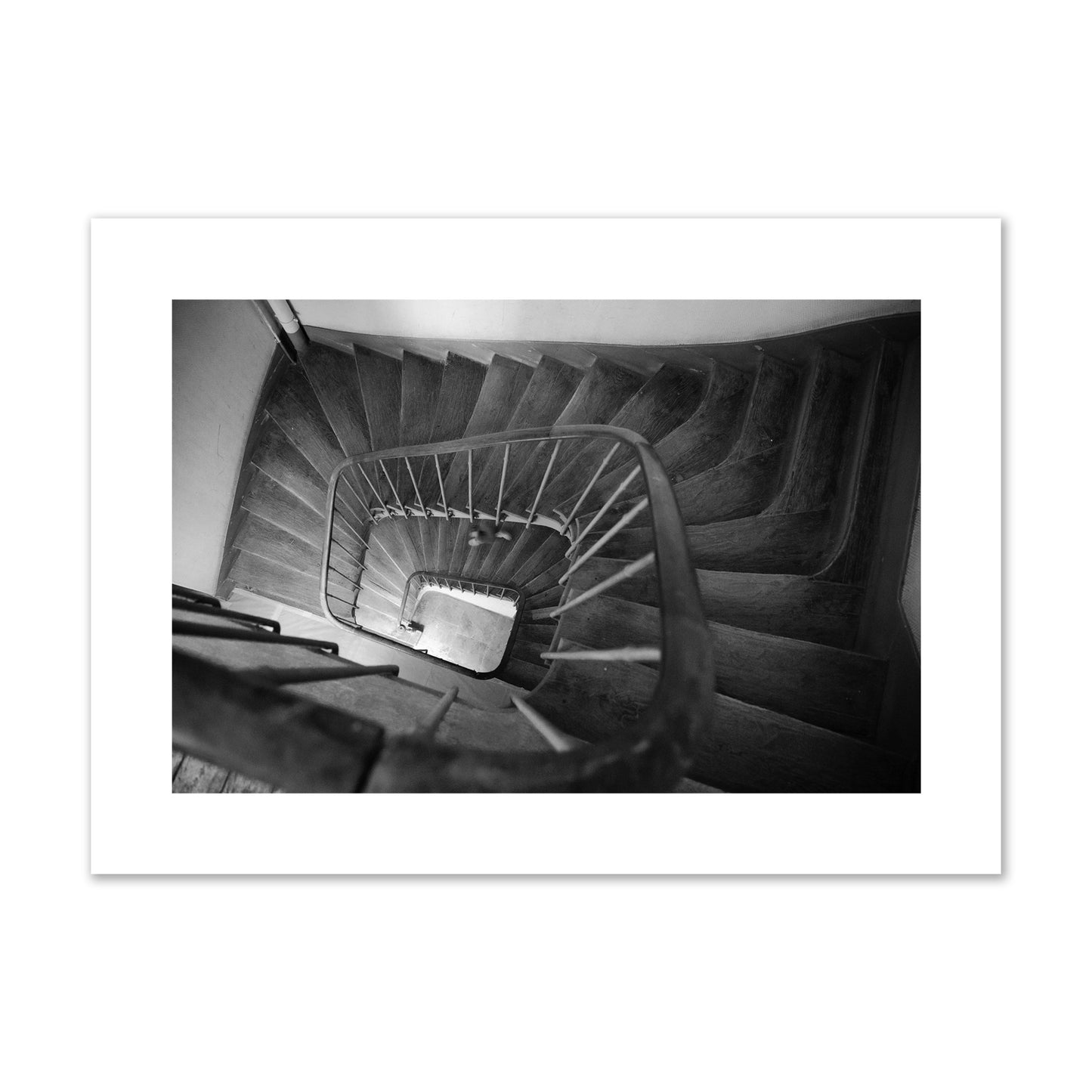 Fine art street photograph of a person walking down a staircase in Paris, France, archival pigment print, large size, unframed